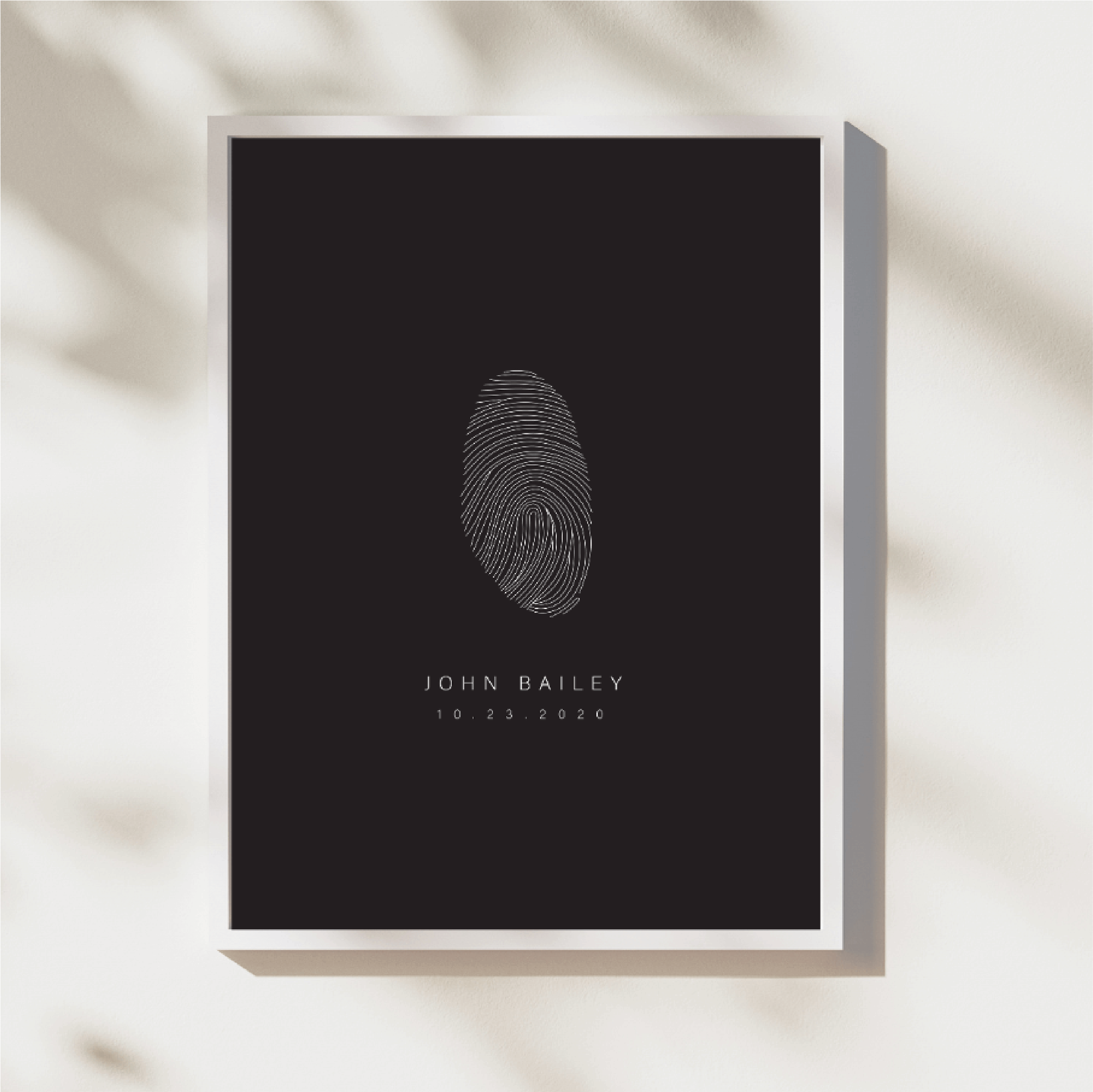 This photo is of Danibydsgn's Fingerprint Art, where we transformed a singular fingerprint into a piece of fingerprint art, perfect for home décor, wall art or to be engraved onto our Danibydsgn custom jewelry. Celebrate life's special memories with Fingerprint Artwork that doubles as wall art or a custom jewelry piece, offering a unique fingerprint design to honour your individuality. In this case the design was for John Bailey which is white on a black background, framed and used as wall art.
