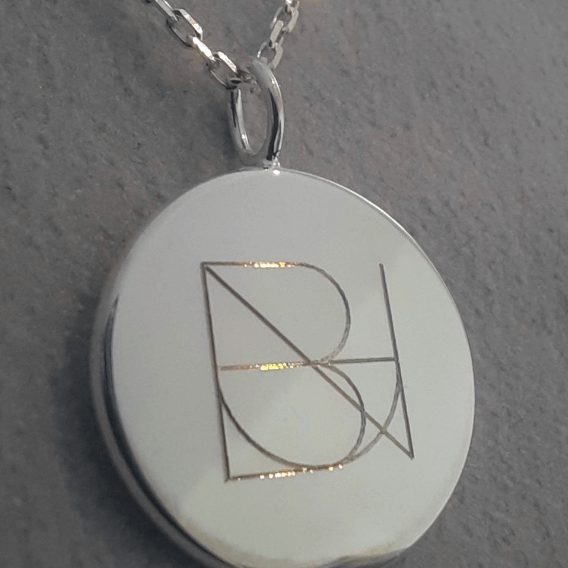 Our luxury bespoke Danibydsgn pendant necklace, elegantly created from 925 sterling silver and engraved with a Danibydsgn custom name logo creates a personal touch. As a refined engraved necklace and keepsake necklace, it's an impeccable choice for those seeking a custom engraved necklace or a stylish memorial necklace. Available also in premium 9ct gold and 18k gold vermeil, this necklace captures the essence of a personalized luxury, making it more than just a piece of jewelry but a cherished keepsake.