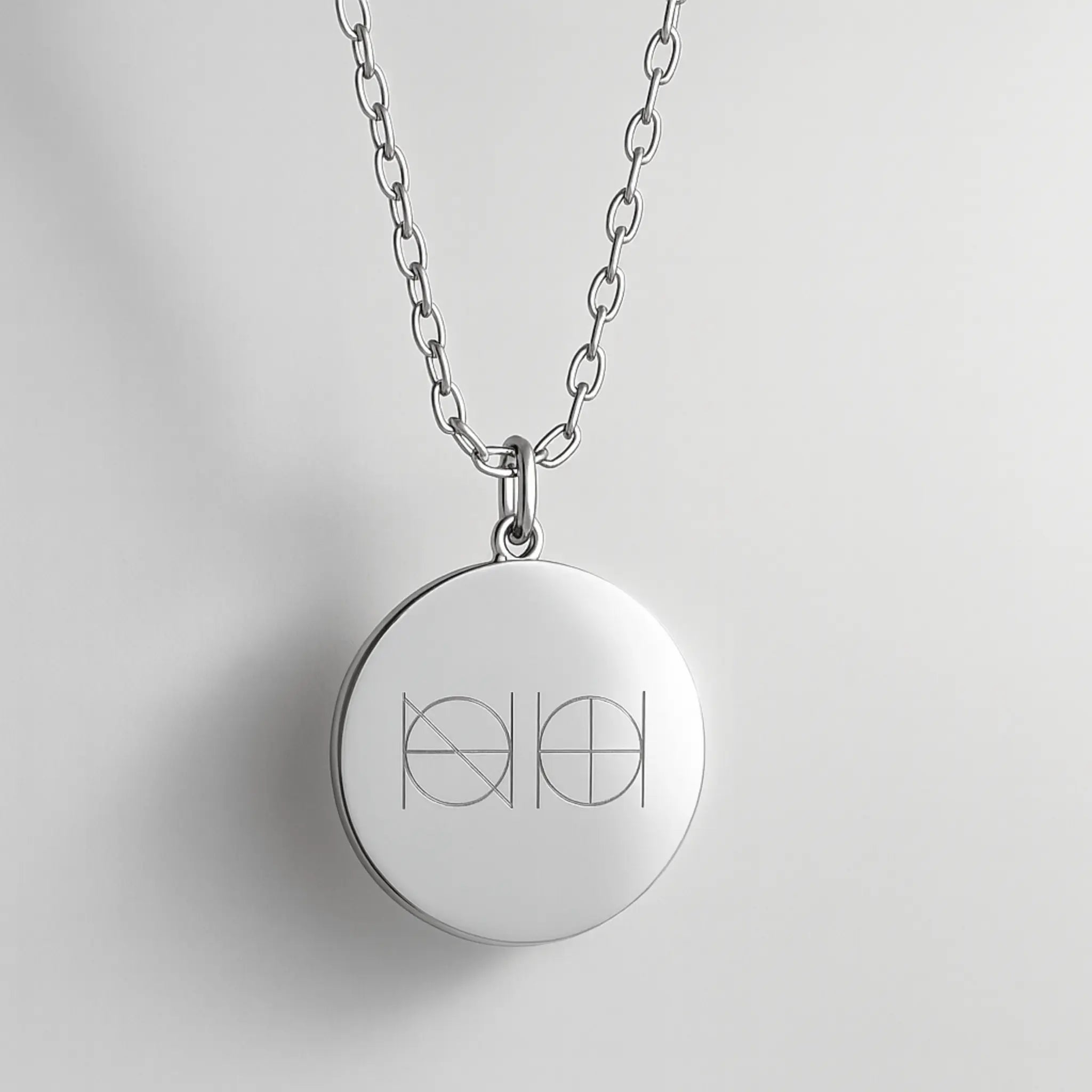 Close-up of Danibydsgn engraved pendant necklace in 925 sterling silver with custom design details.