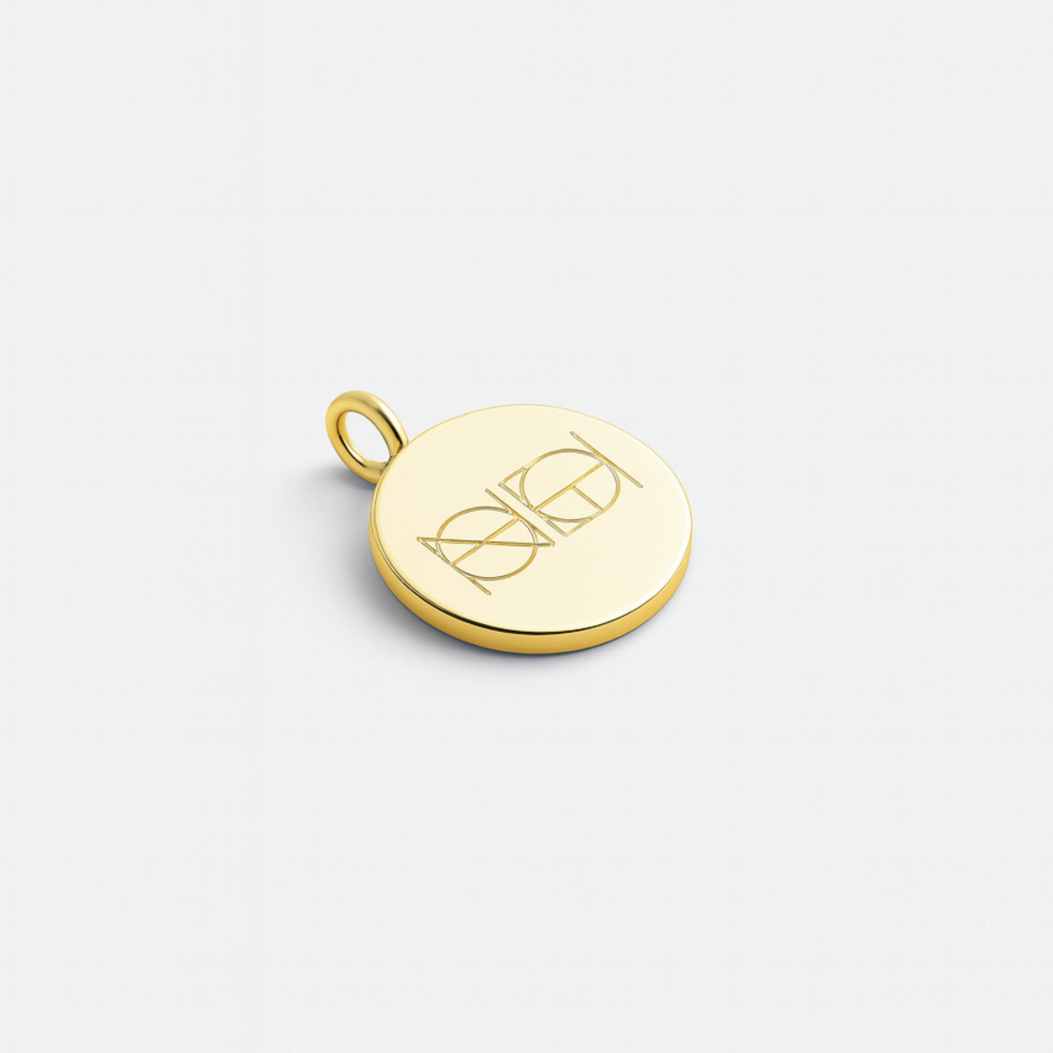 Danibydsgn custom engraved coin pendant in 18k gold vermeil featuring the elegant two-symbol logo design engraved onto a polished gold surface, displayed on a minimalist background.