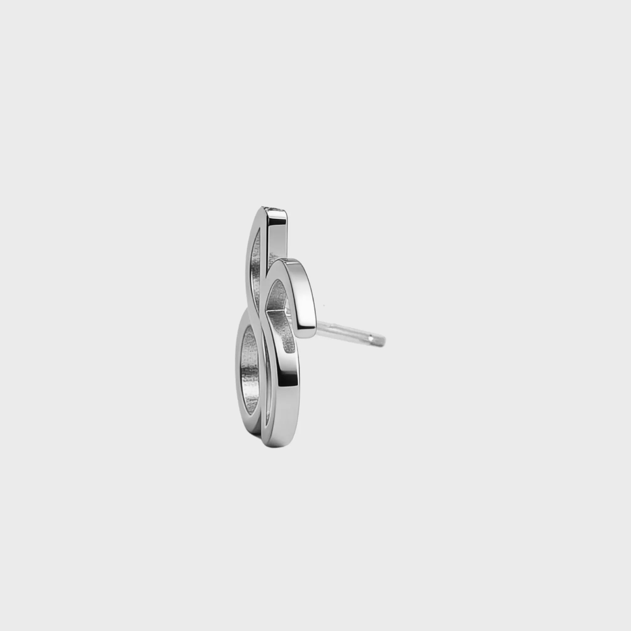 Side view of Danibydsgn custom symbol stud earring in 925 sterling silver, showing the cut-out silhouette depth and stud post.