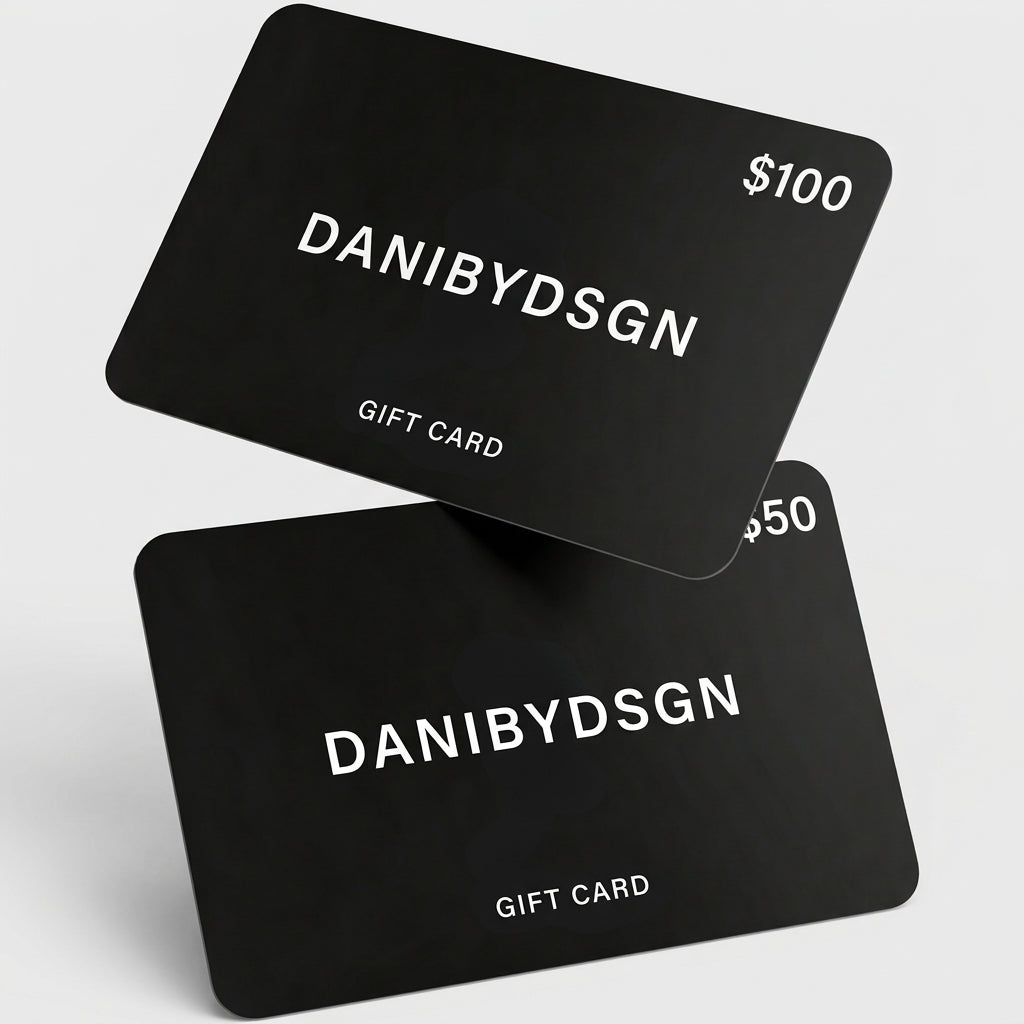 Two Danibydsgn black digital gift card with 'DANIBYDSGN' branding and $100 in the top right hand corner of the top card and the same with $50 on the bottom card. Cards are set against a light gray background. Digital e-gift cards from Danibydsgn,