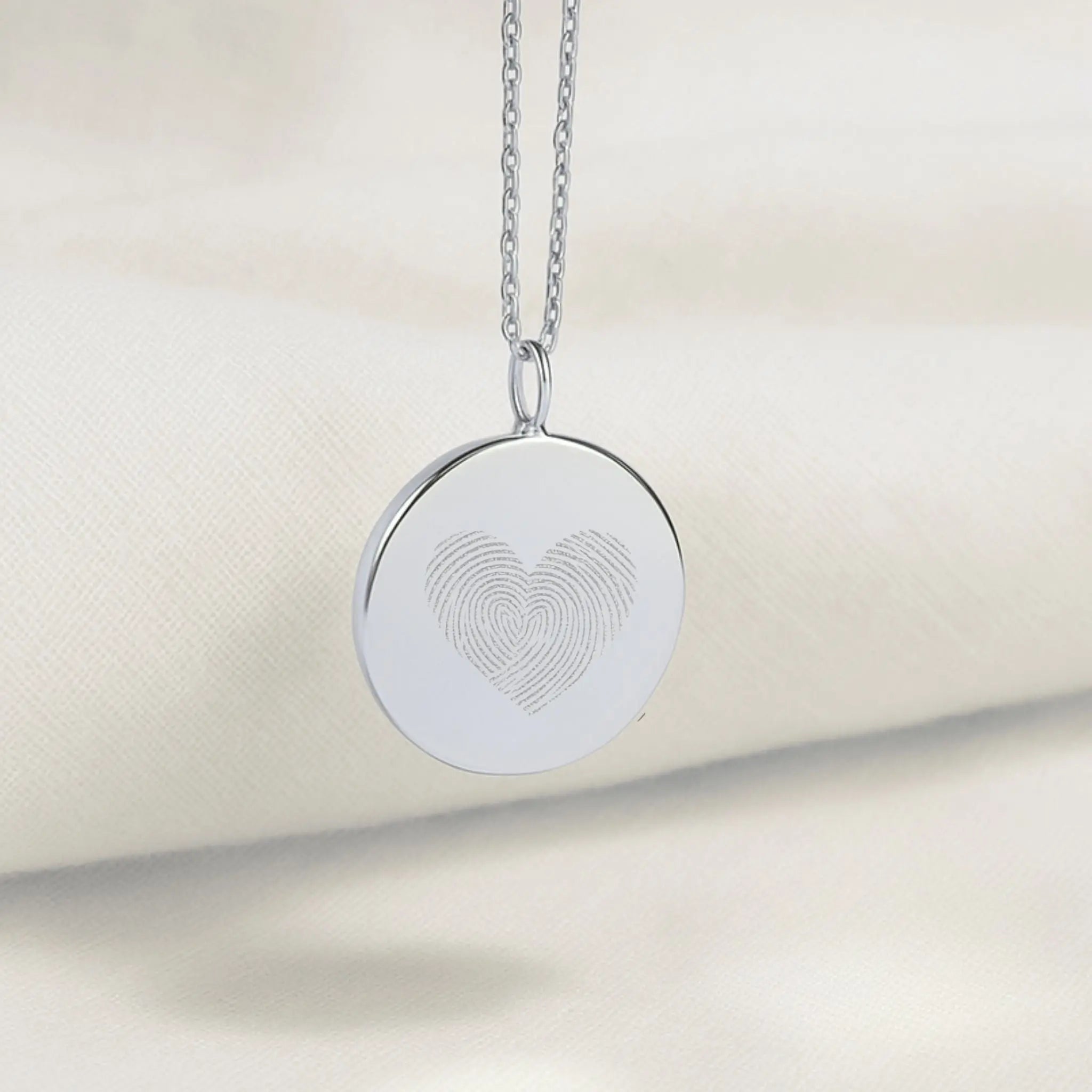The Danibydsgn Heart Fingerprint Coin Pendant Necklace in 925 Sterling Silver, featuring two fingerprints delicately engraved into a heart shape — a timeless symbol of love and connection captured in luxury craftsmanship.