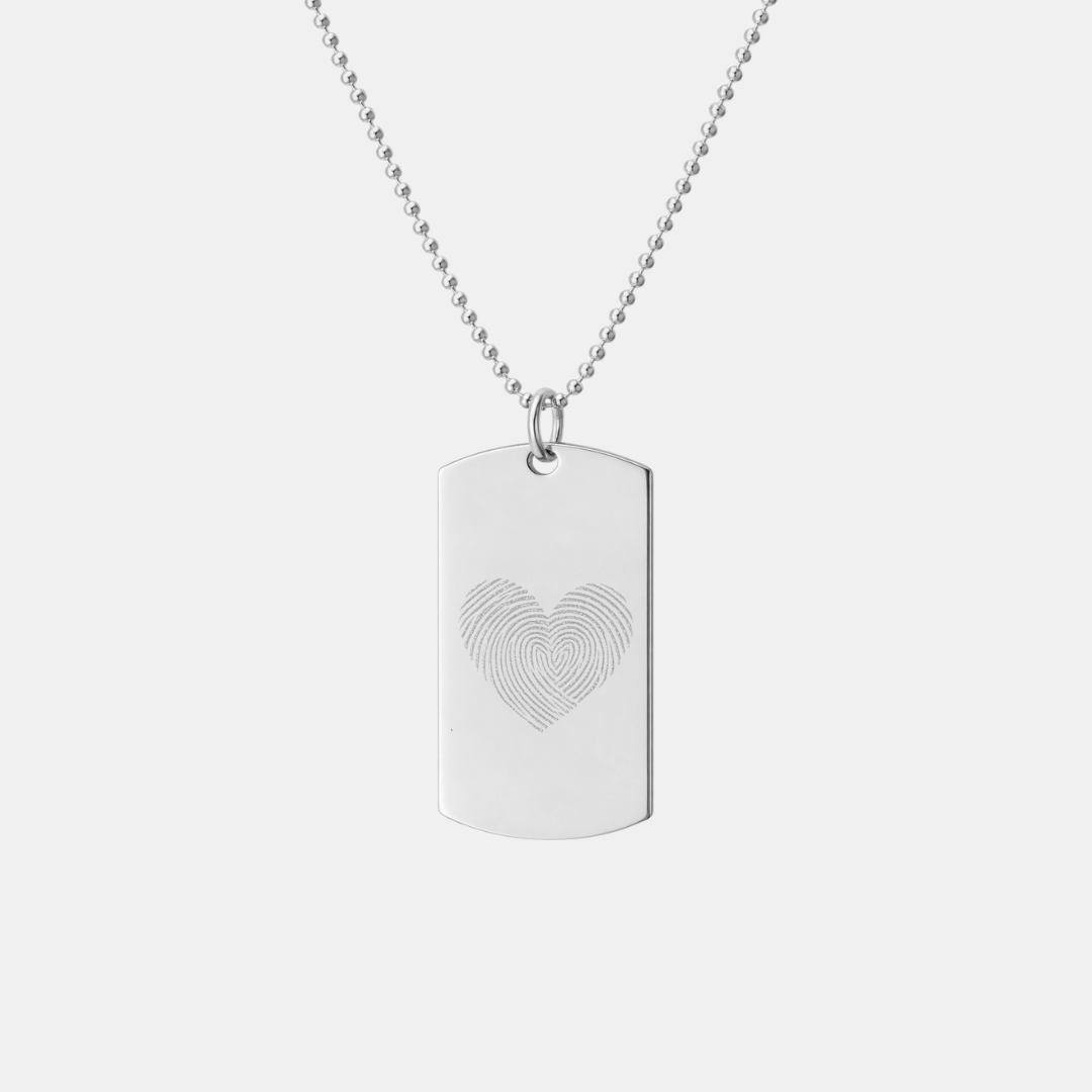 Danibydsgn 925 sterling silver dog tag pendant with custom diamond-engraved heart-shaped fingerprint design, displayed hanging on adjustable bead chain