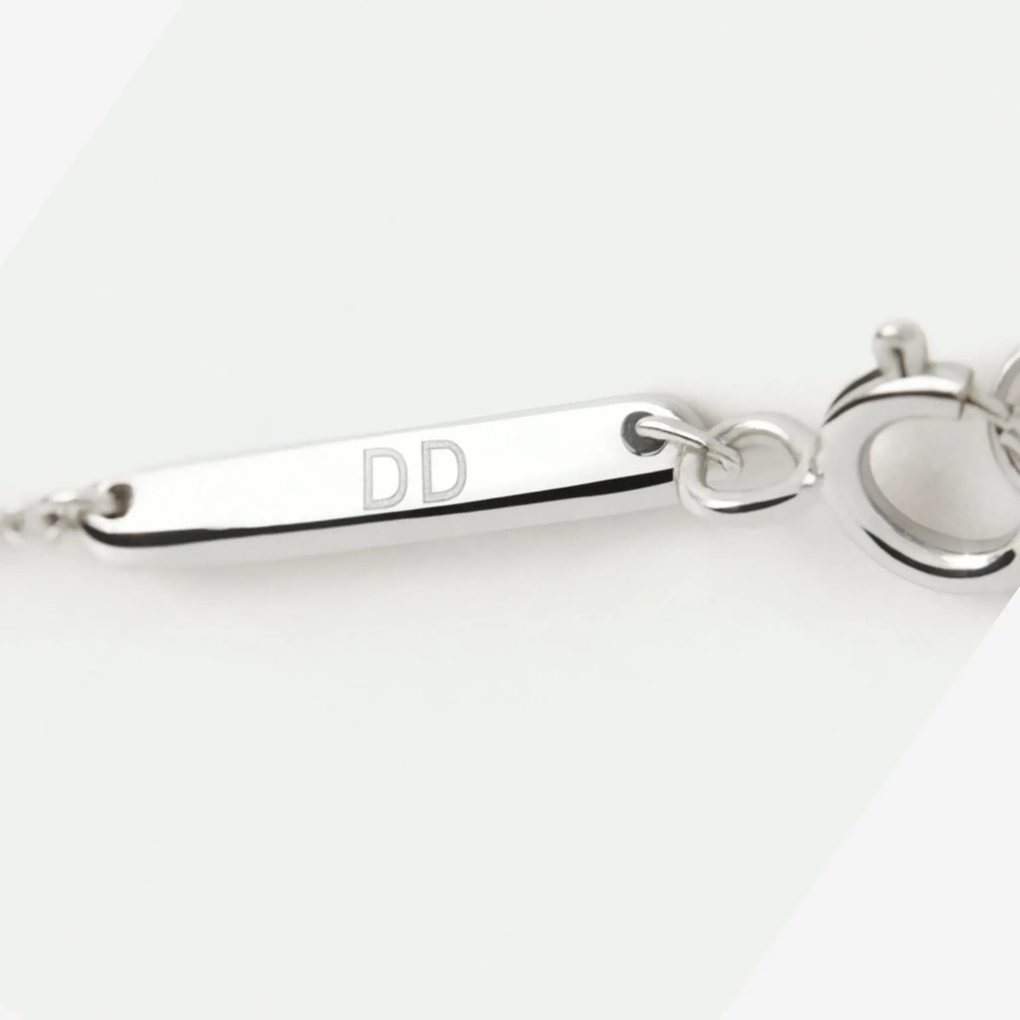 Two Fingerprint Coin Necklace in 925 Sterling Silver by Danibydsgn with a branded tag displayed on a soft surface.