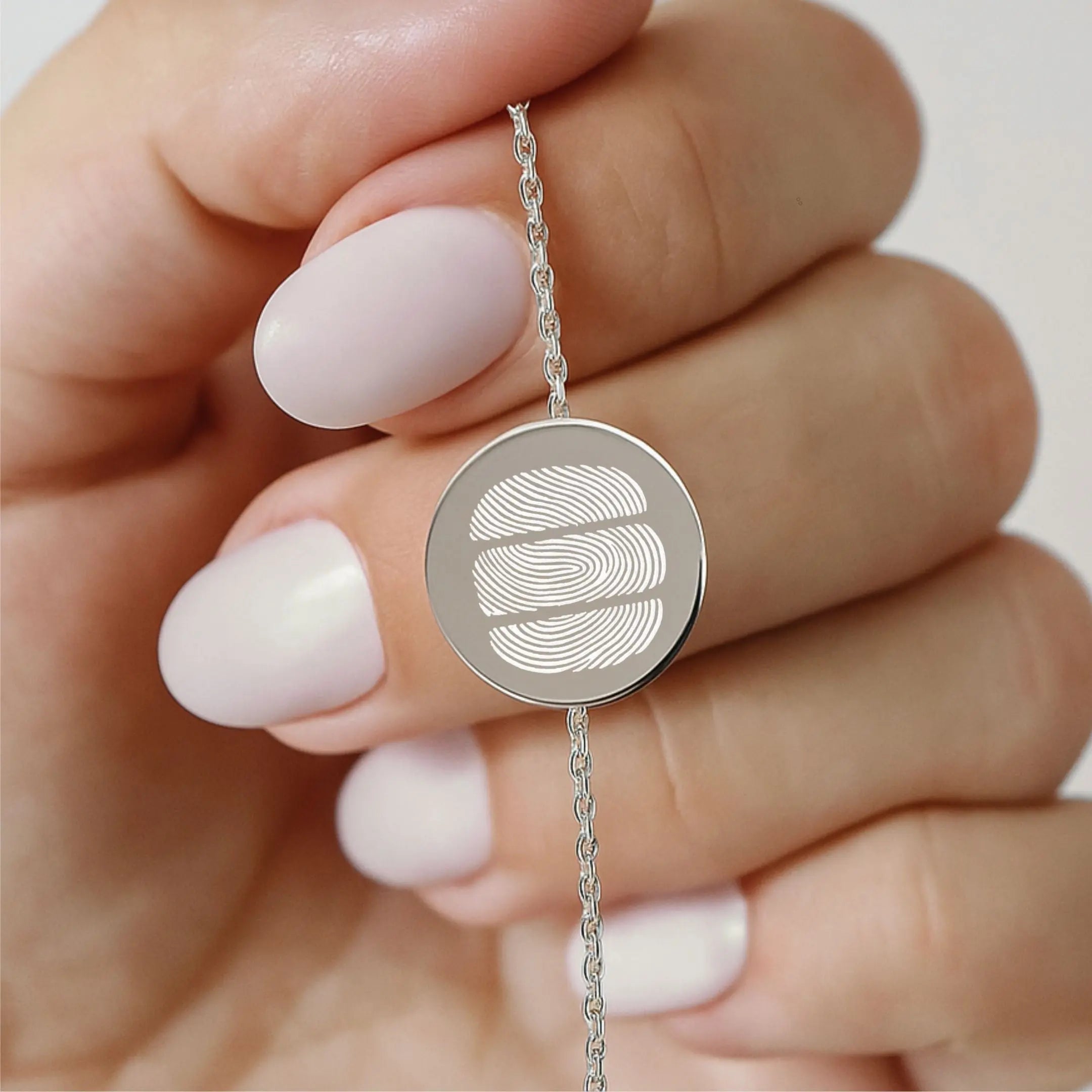 Close-up of Danibydsgn three fingerprint coin bracelet in 925 sterling silver, showcasing intricate design and craftsmanship.