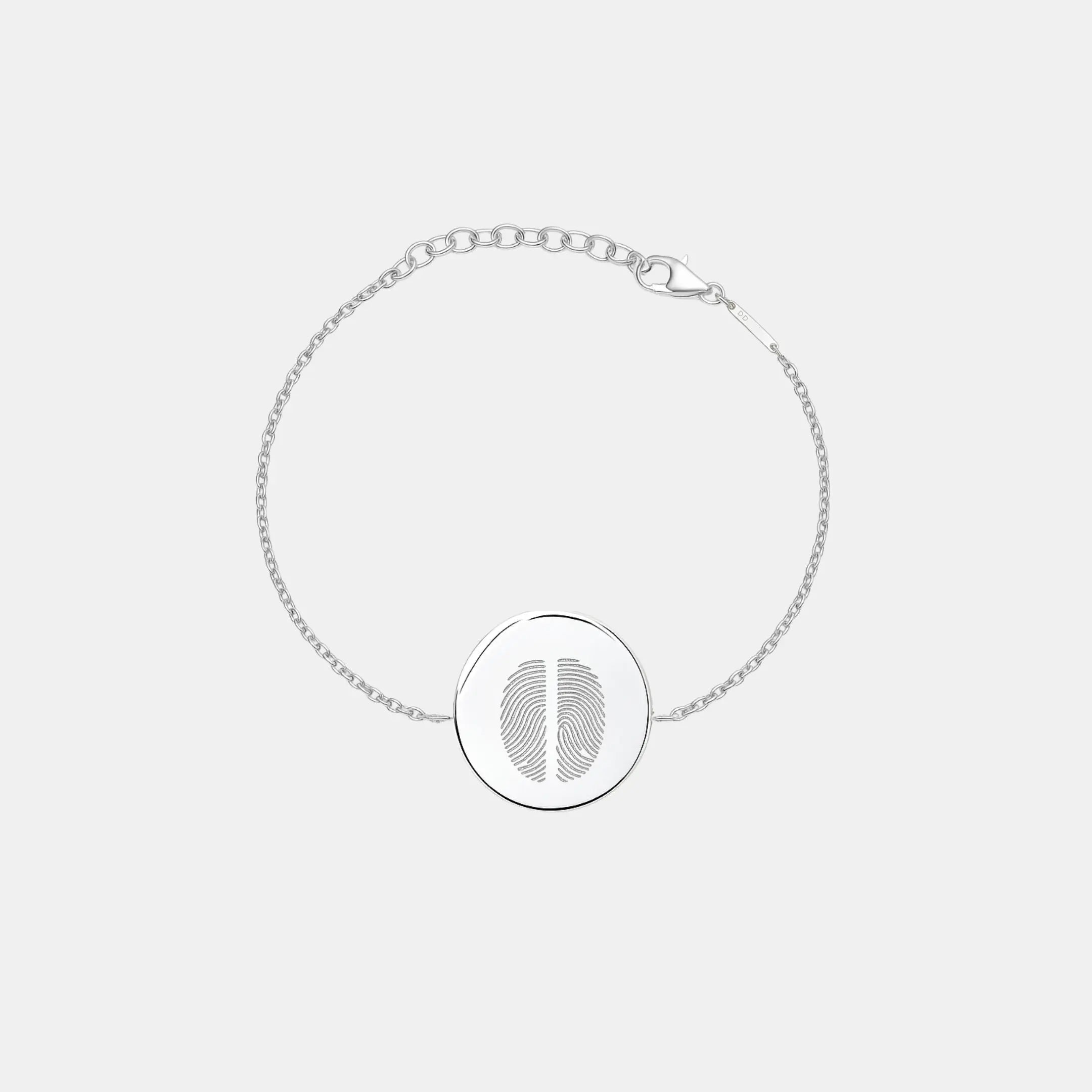 Minimal studio shot of the Danibydsgn Two Fingerprint Coin Bracelet in 925 Sterling Silver, featuring a polished 16mm round pendant engraved with two fingerprints and an adjustable diamond-cut chain for a refined, personal look.