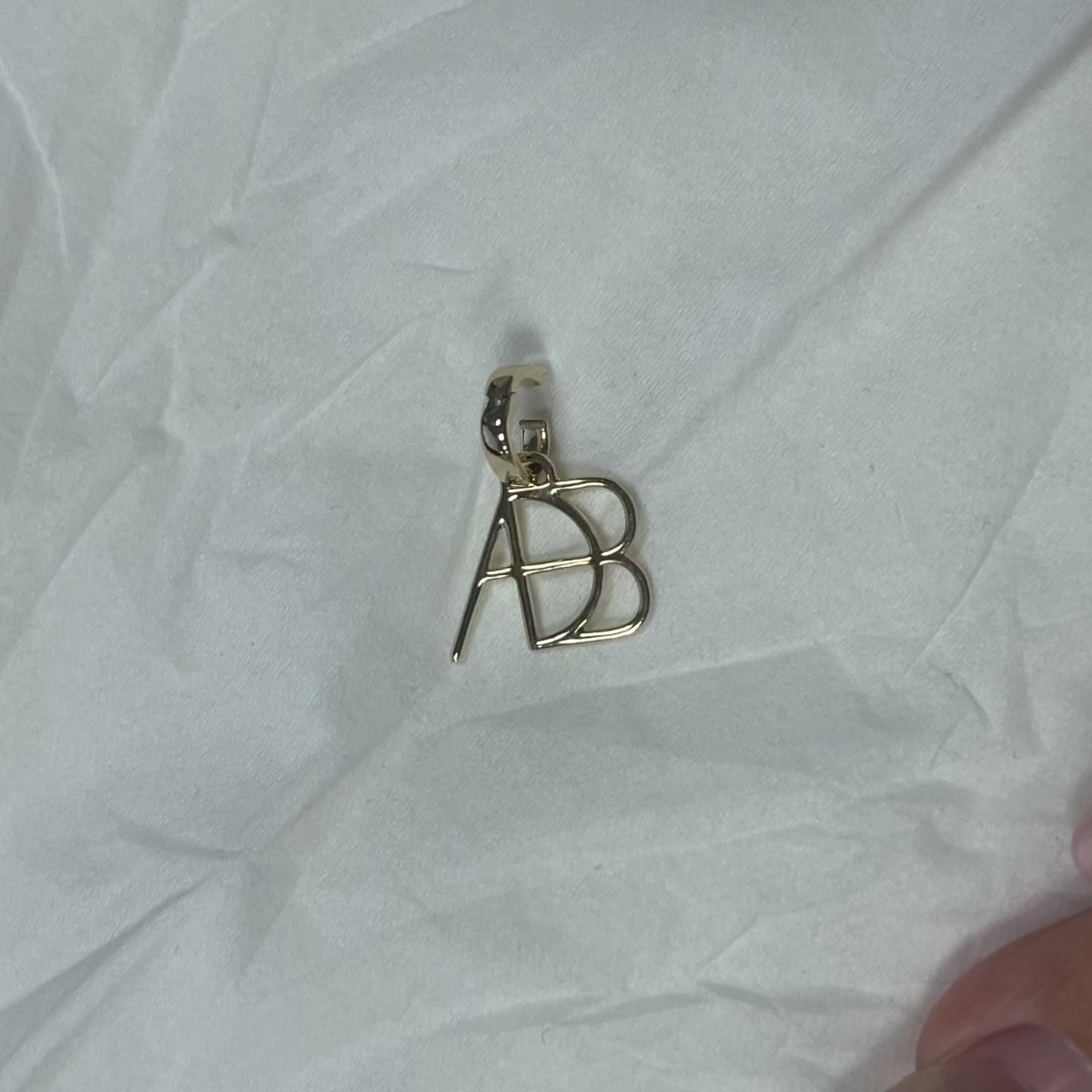 A 9k solid gold clip-on charm created from a Danibydsgn custom design. Handmade cut out symbol to add to existing jewelry or as a stand ablone pendant. Clips on to a chain, bracelet, tennis necklace or any other jewlry piece you may want to add it to. Meaningful modern heirloom jewlry from Danibydsgn