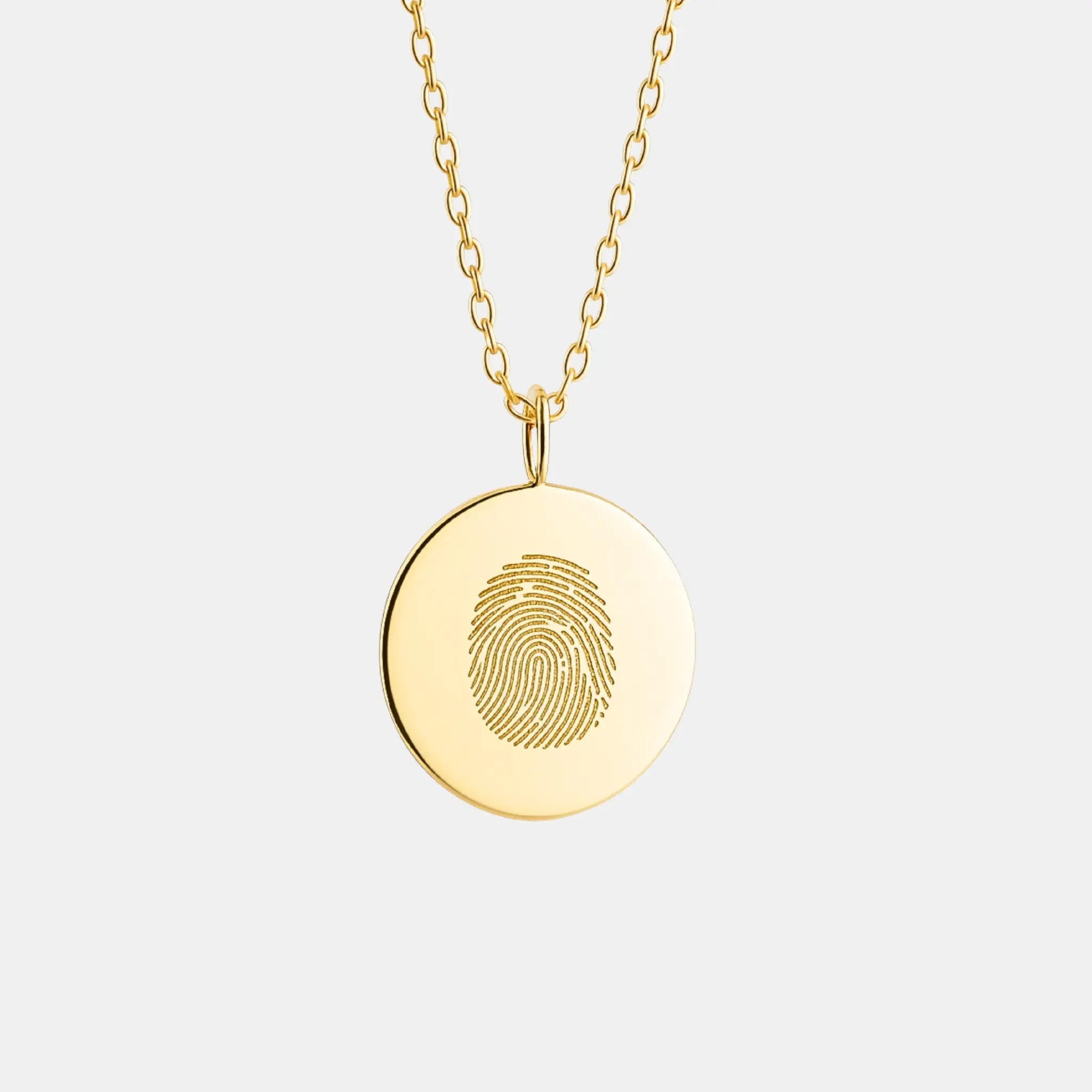 Single fingerprint coin necklace in 18k gold vermeil by Danibydsgn, showcasing detailed fingerprint engraving.
