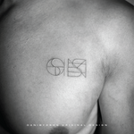 An elegant black-and-white photo showing a fineline tattoo, consisting of two overlapping symbols by Danibydsgn. This custom tattoo design captures the artistry of personal branding through body art, symbolizing meaning and significant to my client.  The custom logo design is discrete yet meaningful.  With over 30,000 designs completed globally and more than 1,700+ five-star reviews, Danibydsgn has a reputation for excellence in personal branding and graphic design. 
