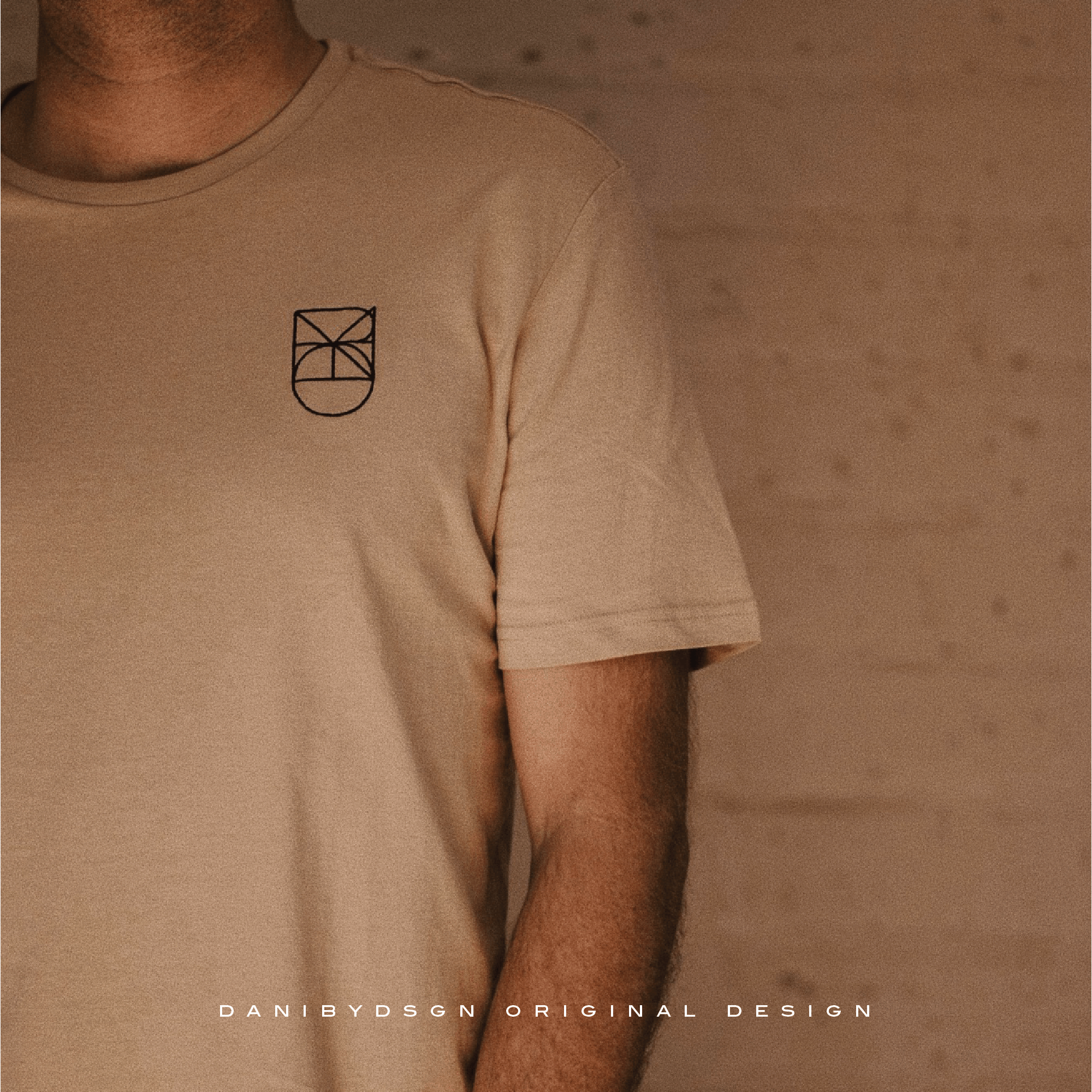 A casual t-shirt featuring a unique geometric Business Logo Design by Danibydsgn, symbolizing a modern approach to clothing branding. This image highlights the artistry of business logo designers and the strategic expertise in business branding, specifically tailored for small business logo needs. The emblem illustrates logo identity and name logo design, ideal for website brand logo representation. Danibydsgn's work as a graphic designer is distinctly evident, reflecting high-standard branding