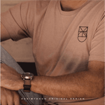 Custom business logo created by Danibydsgn, displayed on a beige t-shirt uniform as part of a complete business branding package showcasing professional brand identity in use.