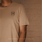 Beige t-shirt displaying the original Danibydsgn business logo, designed to showcase professional brand identity and modern logo branding for businesses.