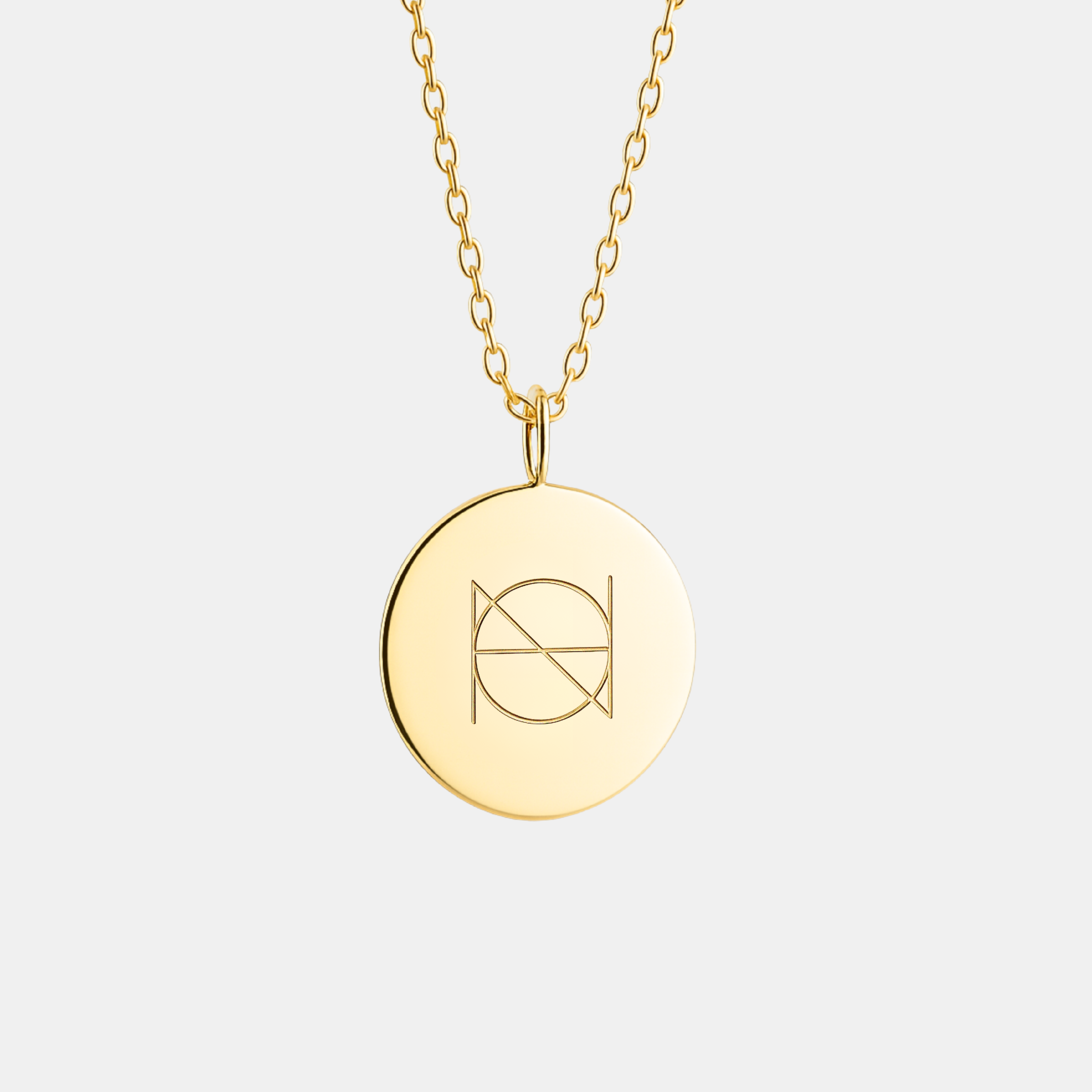 18k Gold Vermeil, Danibydsgn logo with one symbol engraved, luxury, coin pendant necklace on light light background.