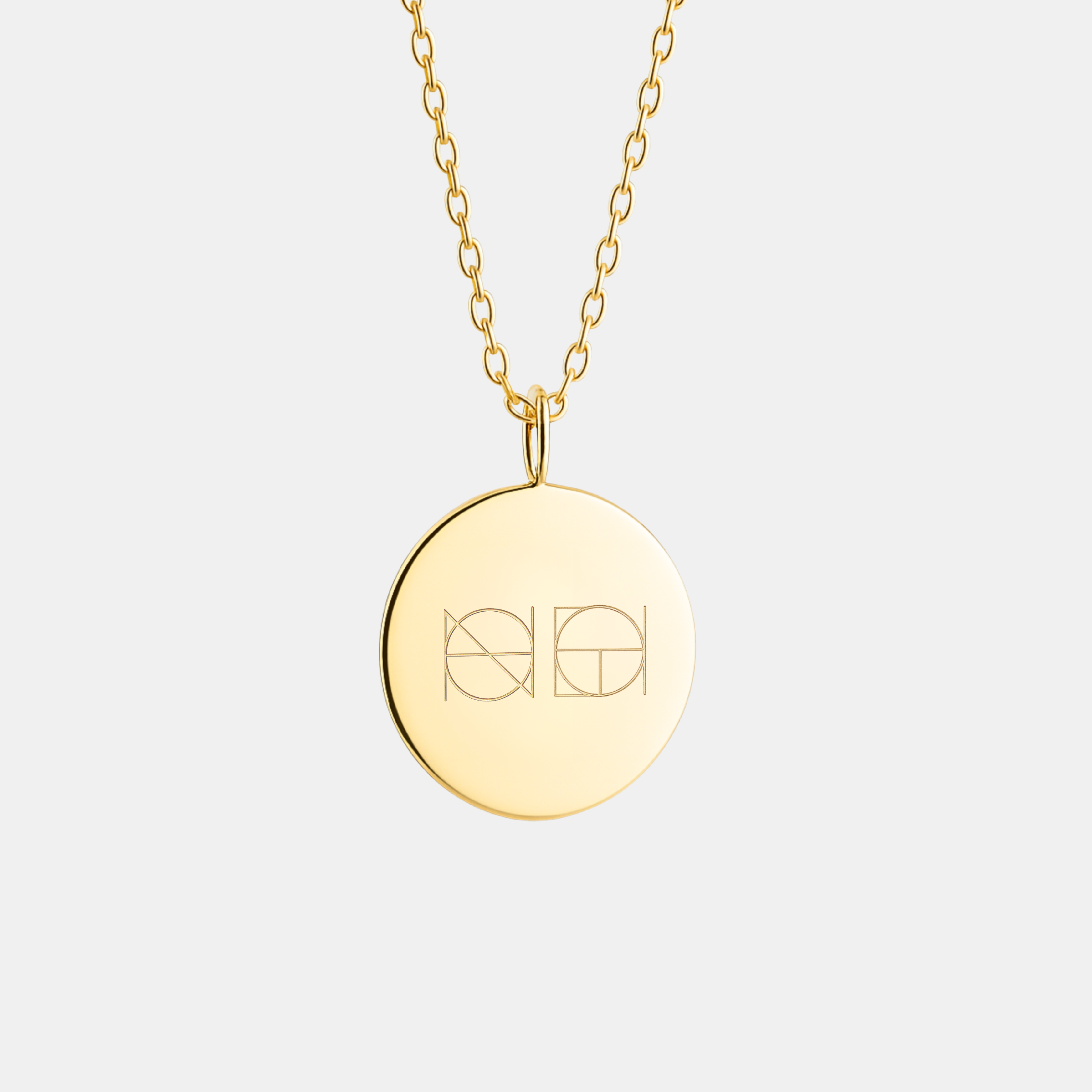 18k Gold Vermeil, Danibydsgn logo with two symbols engraved, luxury, coin pendant necklace on light light background.