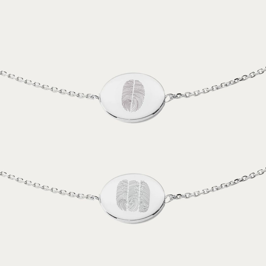 925 sterling silver coin bracelet engraved with personalized fingerprint detail.  Available in single, duo, trio and heart fingerprint design and a symbol of connection and remembrance. This custom fingerprint bracelet is not just jewelry but a wearable memory, a keepsake of precious moments captured in silver. Engrave your most cherished memories into a timeless piece of memorial jewelry, a unique thumb print bracelet that resonates with personalized elegance and intimate craftsmanship.  