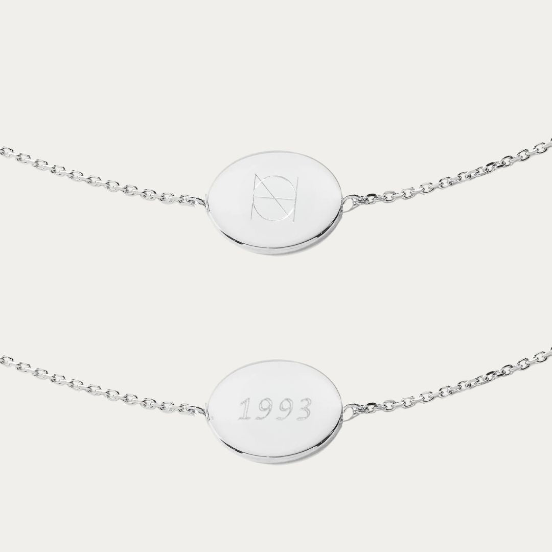 Our 925 Sterling Silver Coin Bracelet, featuring a double-sided pendant engraved with a Danibydsgn custom name logo on one side, symbolizing personal branding and luxury jewelry. This bespoke coin bracelet is a romantic gift, a meaningful gesture that immortalizes memories or milestones.. Each personalized silver bracelet from our collection is not just a piece of engraved jewelry; it's a narrative piece, a keepsake jewelry that's uniquely yours, amplifying the charm of sterling silver with timeless design