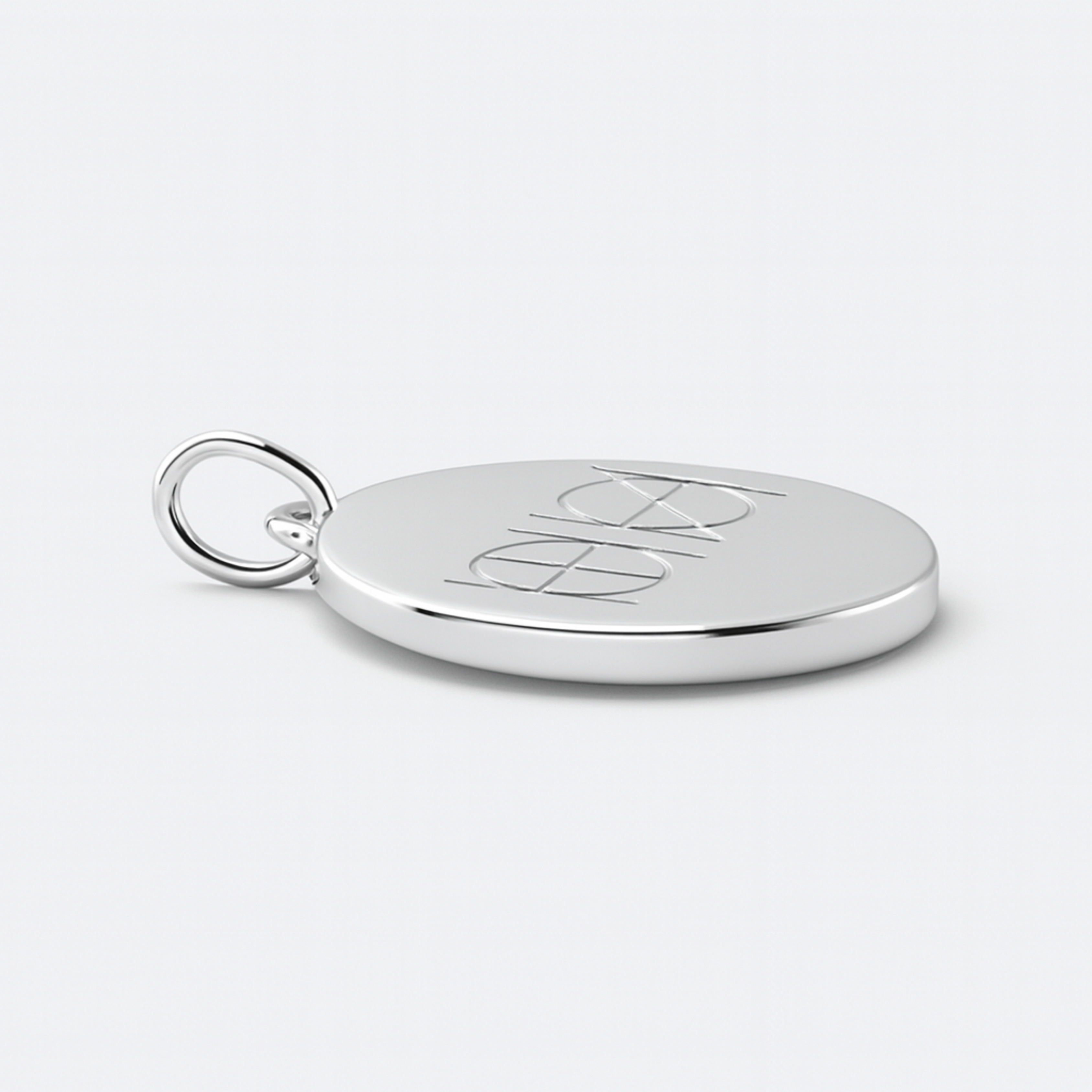 A 925 Sterling Silver coin necklace with an engraved custom Danibydsgn logo design on it, of two symbol on a light coloured background.