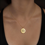 18k Gold Vermeil luxury coin pendant necklace with 3 fingerprints engraved on the pendant and pendant is on a chain around a lady's neck.
