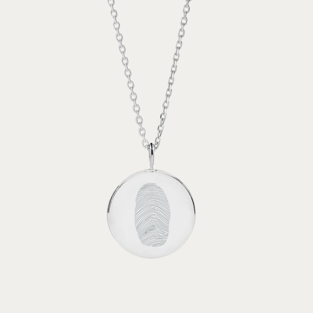 925 Sterling Silver necklace elegantly showcases a single fingerprint, engraved onto a coin pendant necklace. As part of the exclusive Danibydsgn fingerprint necklace line, it offers a blend of luxury and individuality, making it an ideal personalized gift. Beyond its charm as an engraved necklace, it also carries the sentimental value of memorial jewelry, capturing a loved one's touch in a timeless piece. This signature piece of engraved jewelry is not just a fashion statement but a cherished keepsake