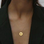 18k Gold Vermeil luxury coin pendant necklace with 2 fingerprints engraved on the pendant and pendant is around the neck of a lady.