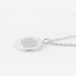 925 Sterling Silver Luxury Coin Pendant necklace on a chain with three fingerprints engraved on the pentand.  Close up and pendant is on a light coloured background. 