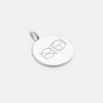 A 925 Sterling Silver coin necklace with an engraved custom Danibydsgn logo design on it, of two symbols on a light coloured background.
