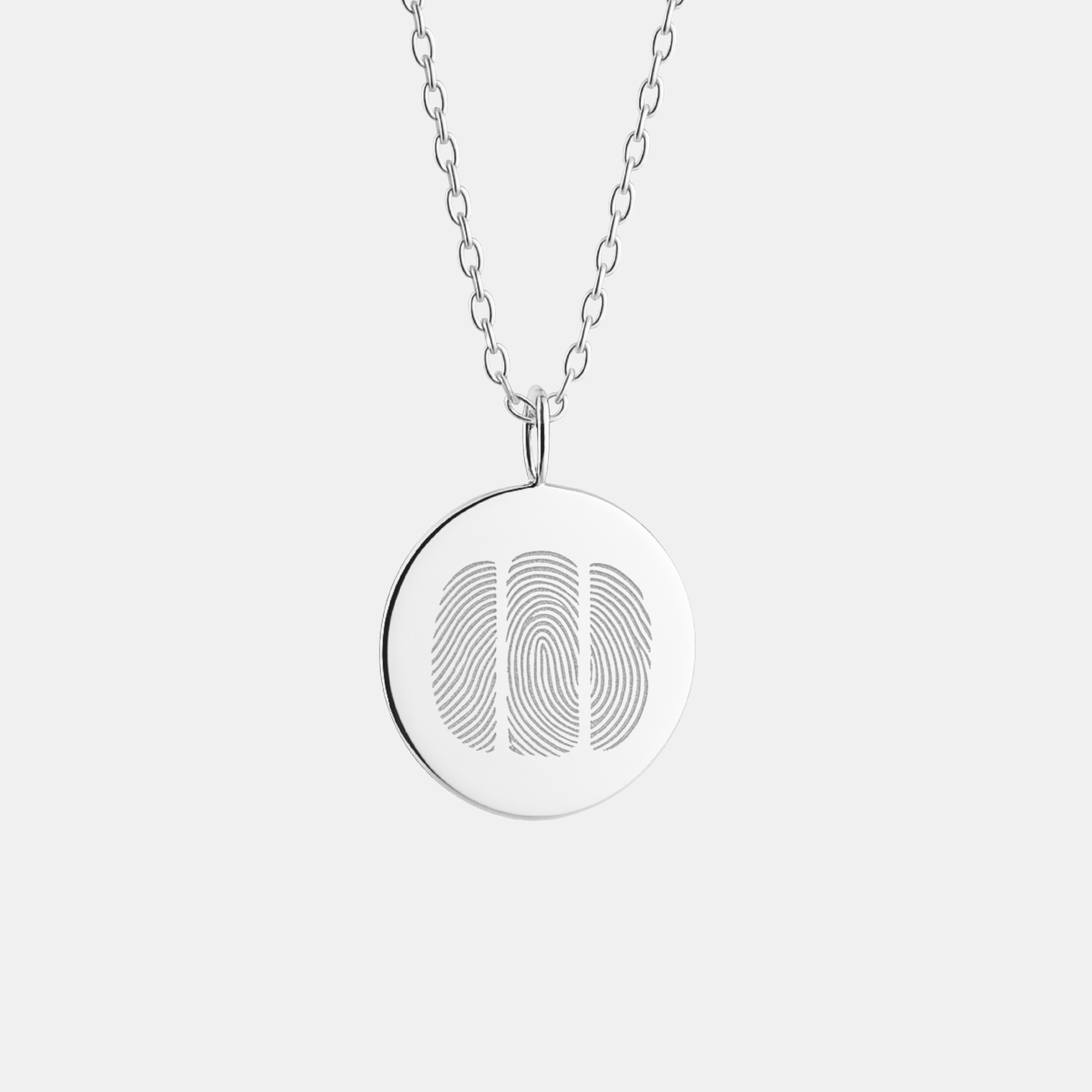 Silver necklace with a round pendant featuring a three fingerprint design on a white background and dainty cable chain.
