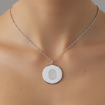 925 sterling silver luxury coin pendant necklace with 1 fingerprint engraved on the pendant and pendant is around the neck of a lady.