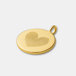 18k Gold Vermeil luxury coin pendant necklace with 2 fingerprints in the shape of a heart engraved on the pendant and photo is of a close up of thependant on a light coloured background