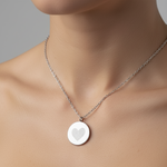 925 sterling silver luxury coin pendant necklace with heart fingerprints engraved on the pendant and pendant is around the neck of a lady.