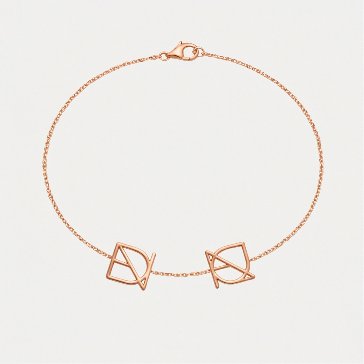 A delicate 9k rose gold, Danibydsgn symbol cut out two symbol bracelet  displayed on a clean, light off-white background.