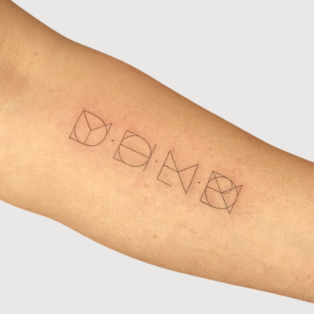 Four custom fine-line geometric symbols tattooed on an arm, showcasing a bespoke meaningful tattoo design created from personal stories.