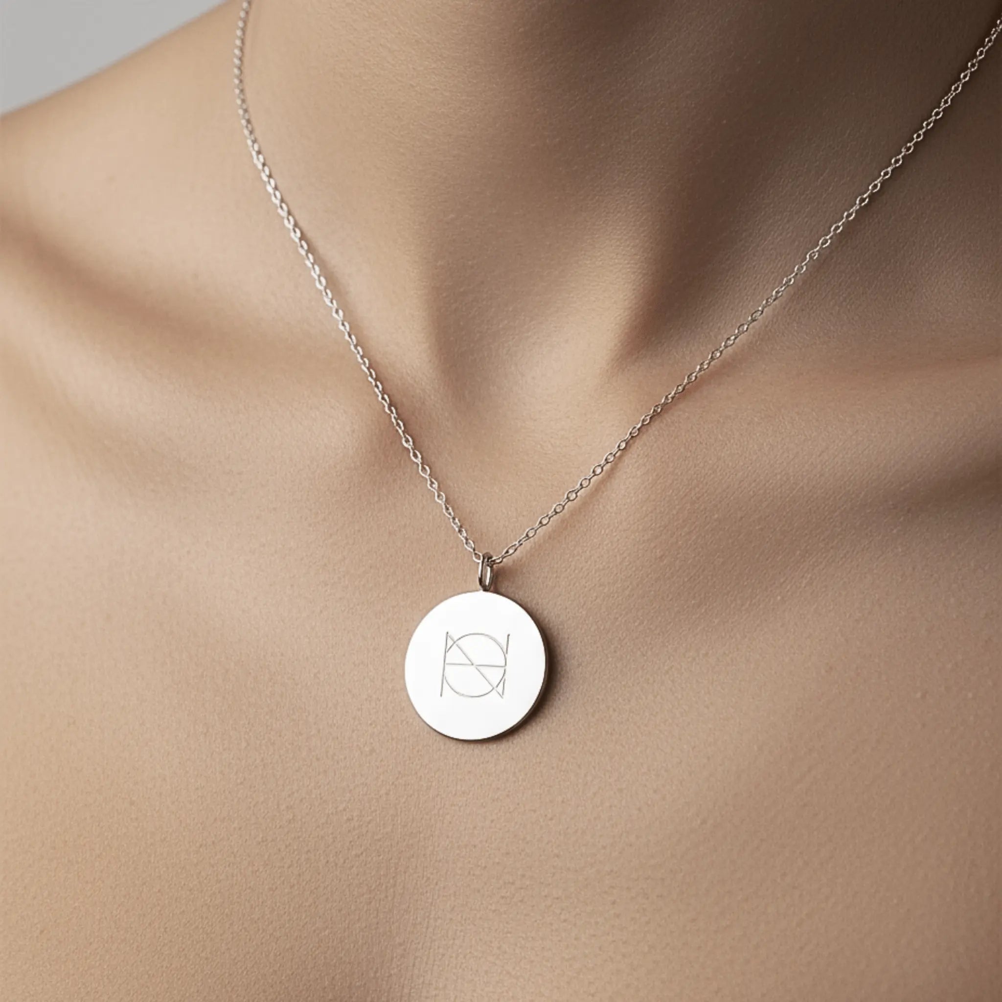 Close-up of Danibydsgn custom engraved coin necklace in 925 sterling silver, showcasing detailed engraving and elegant design.