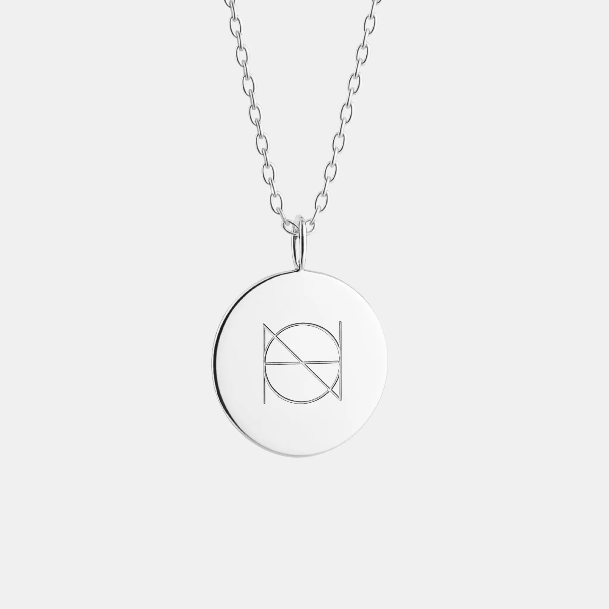 Custom engraved coin necklace in 925 sterling silver featuring a single symbol by Danibydsgn.