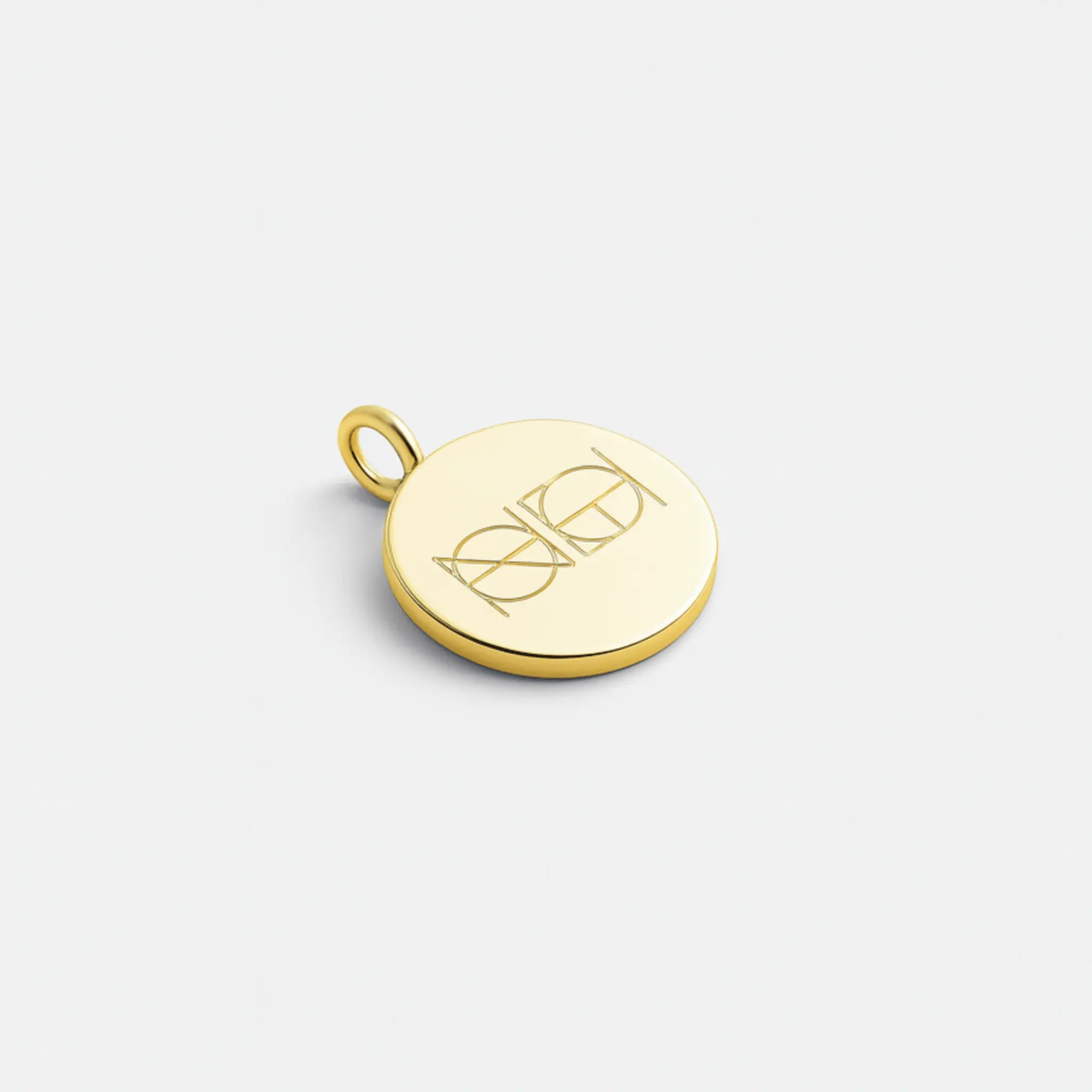Custom engraved coin pendant necklace in 18k gold vermeil by Danibydsgn featuring a two-symbol logo design.