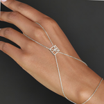 Model wearing Danibydsgn custom symbol hand chain in 925 sterling silver, with a geometric cut-out symbol connector across the back of the hand.