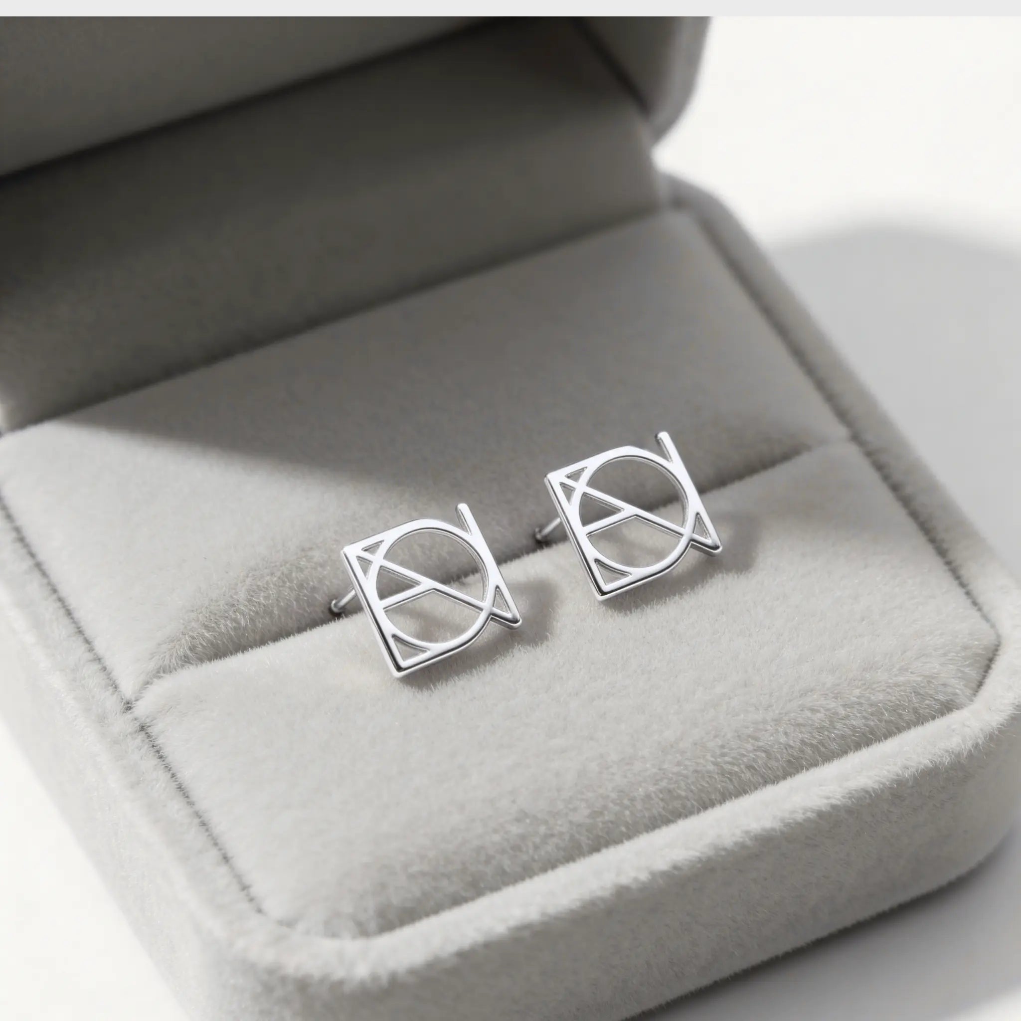Danibydsgn custom symbol earings in 925 sterling silver, custom made, design is in upper case letters and displayed in a beaufiful light coloured jewelry gift box. 