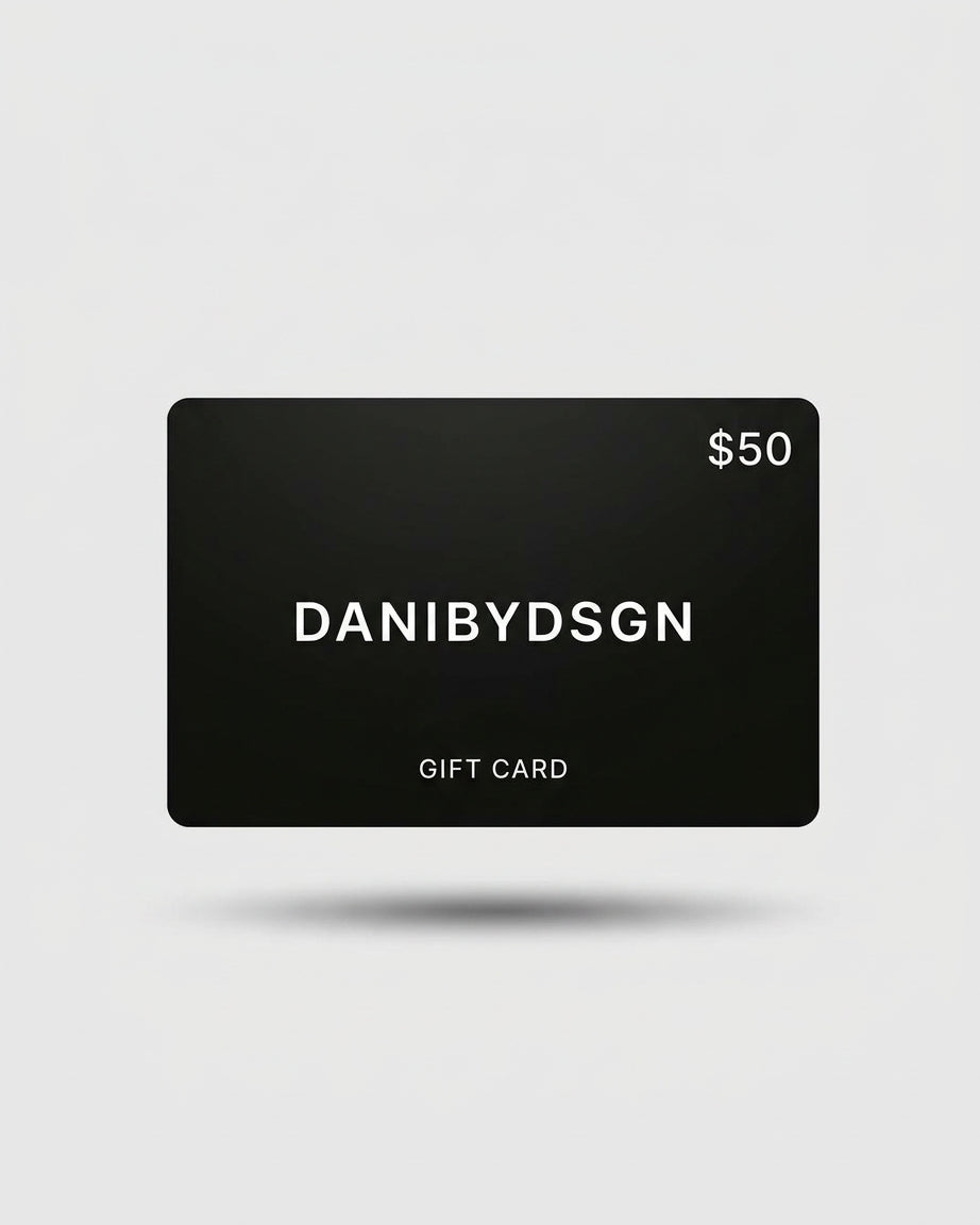 Close up of a Danibydsgn  $50 black digital gift card with 'DANIBYDSGN' branding and $50 in the top right hand corner of the card.  Card is set against a light background.  Digital e-gift cards from Danibydsgn.