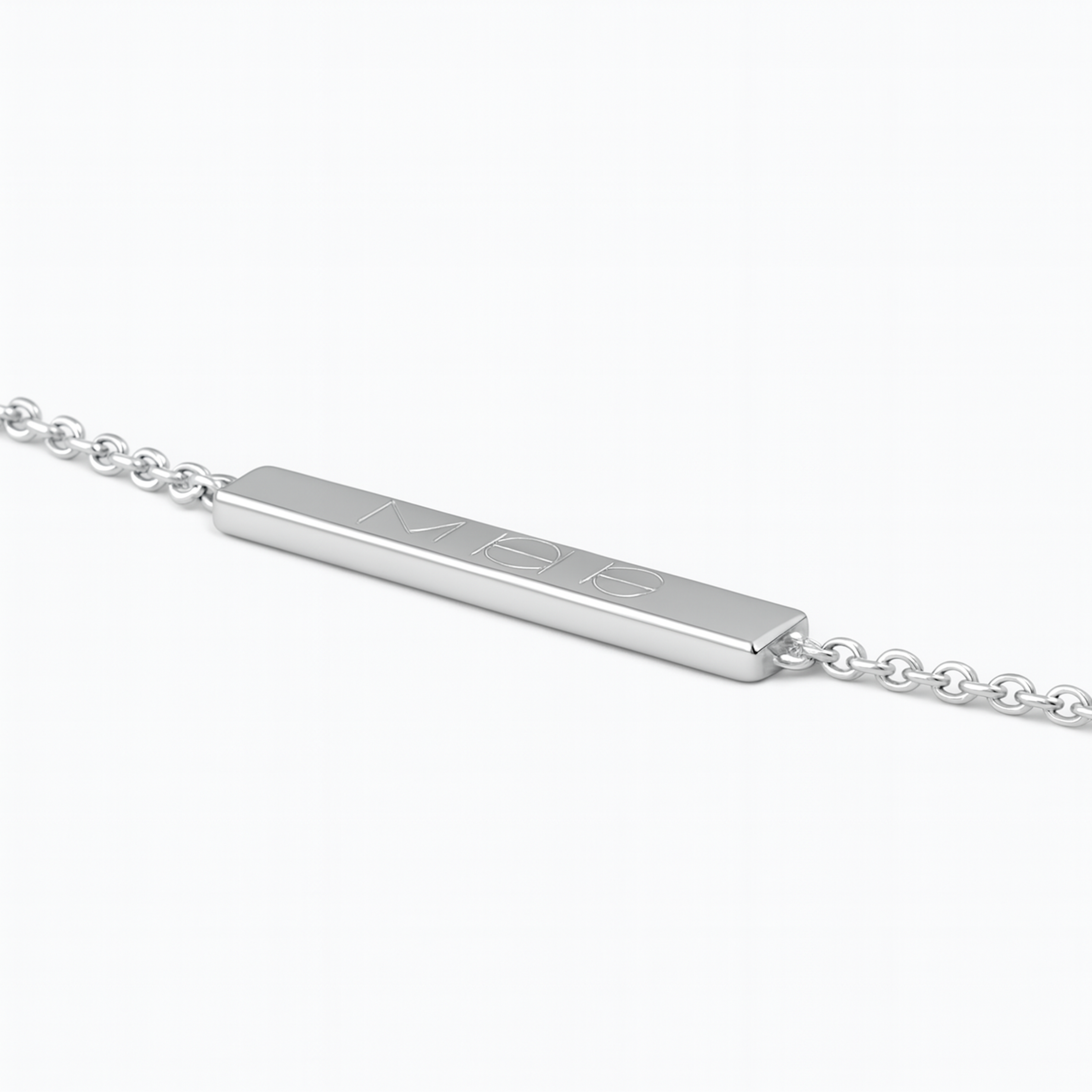 Angled close-up of the Danibydsgn engravable bar bracelet in 925 sterling silver, showing the slim rectangular plate engraved with a three-symbol geometric logo and attached to a fine silver chain.