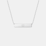 Front view of the Danibydsgn engraved bar necklace in 925 sterling silver, featuring a minimalist rectangular pendant engraved with a two-symbol geometric design, suspended from a fine silver chain.