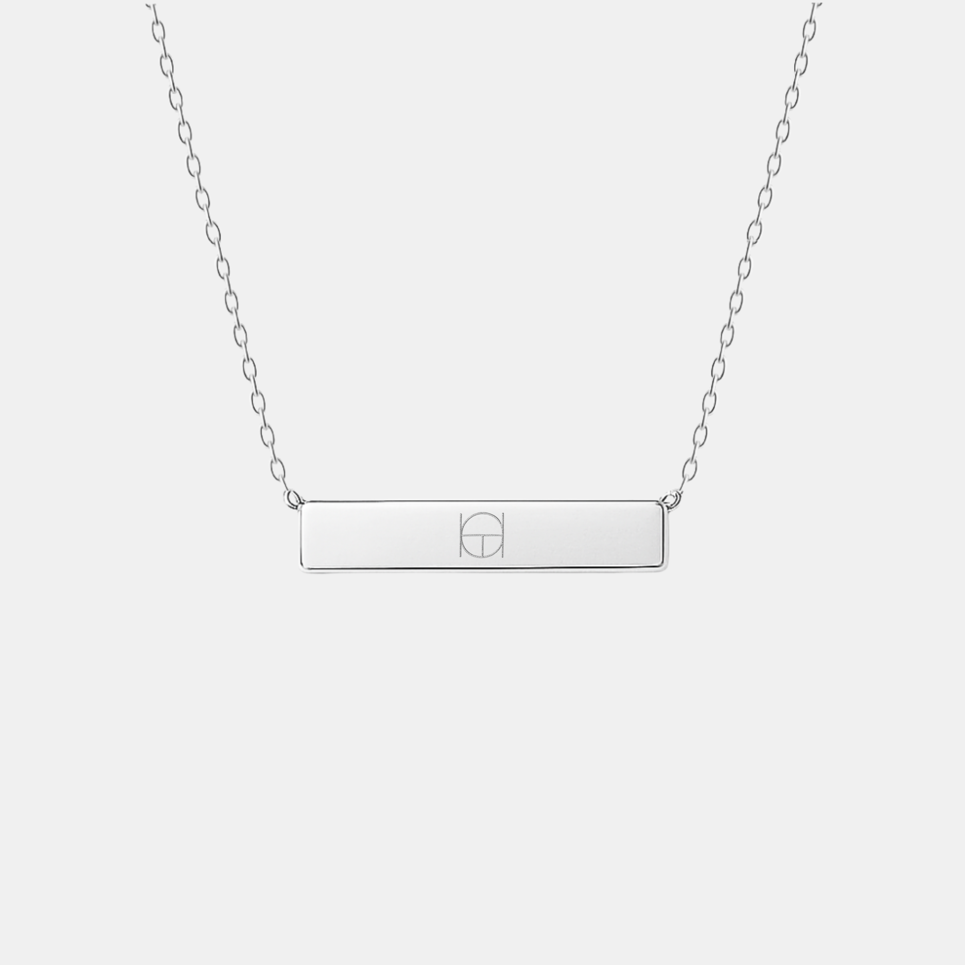 Front view of the Danibydsgn engraved bar necklace in 925 sterling silver, featuring a minimalist rectangular pendant engraved with a two-symbol geometric design, suspended from a fine silver chain.