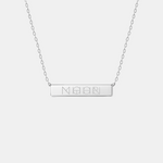 Front view of the Danibydsgn engraved bar necklace in 925 sterling silver, featuring a sleek rectangular pendant engraved with a four-symbol geometric design, suspended from a fine silver chain.