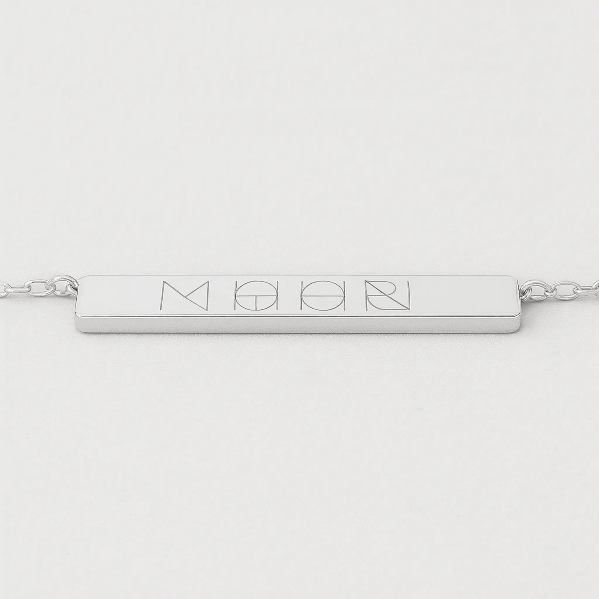 Front view of Danibydsgn engraved bar necklace in 925 sterling silver featuring a four-symbol design.