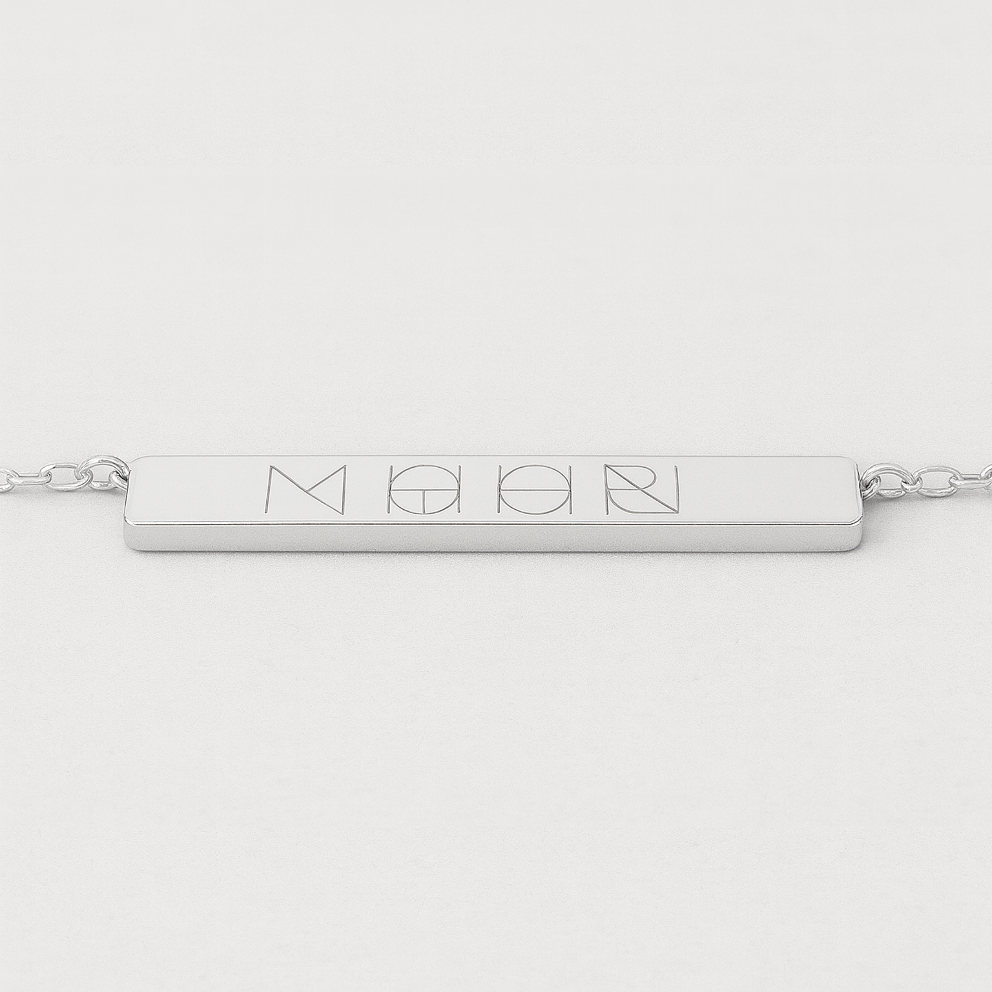 Front view of the Danibydsgn engravable bar necklace in 925 sterling silver, featuring a sleek rectangular bar engraved with a four-symbol geometric logo, attached to a delicate silver chain.