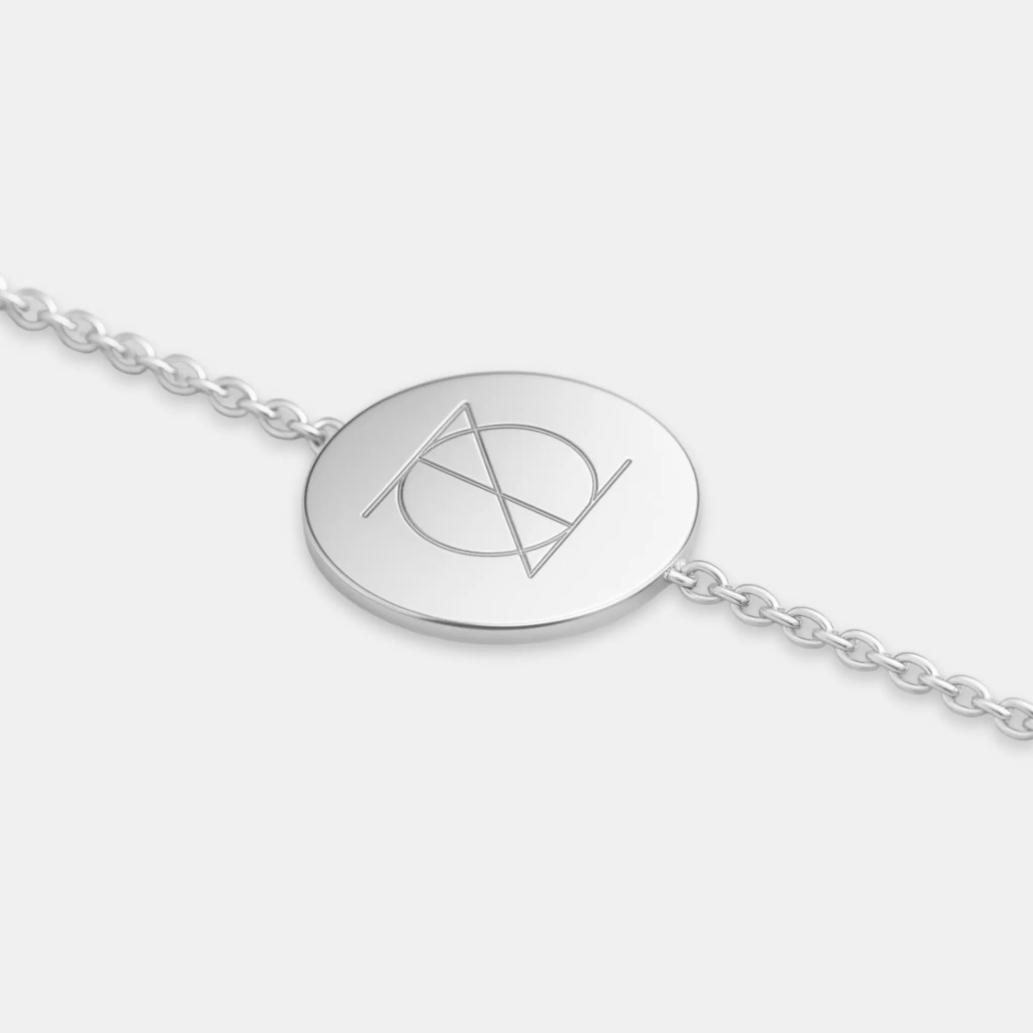 Close-up of Danibydsgn engraved coin bracelet in 925 sterling silver showcasing custom jewelry design.