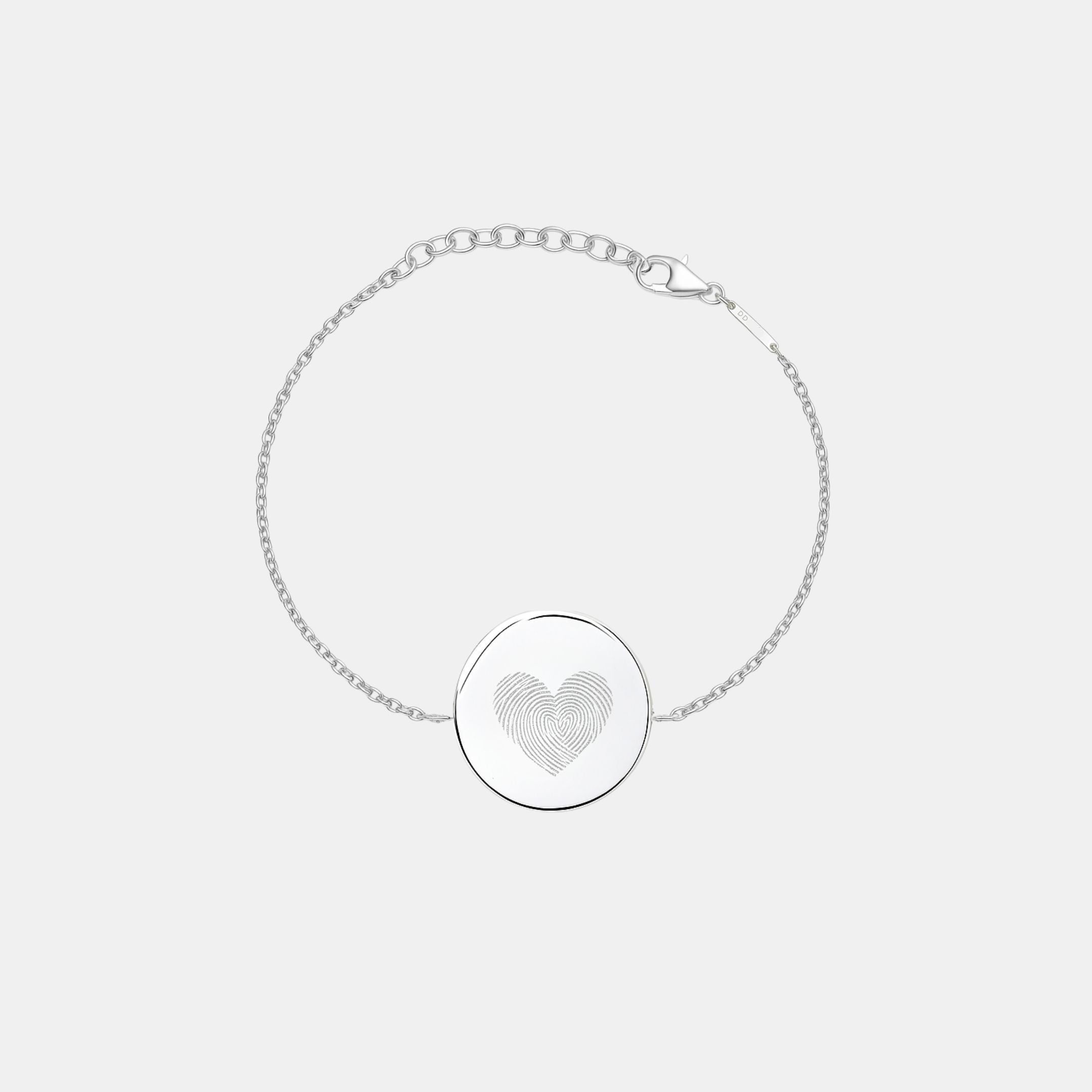 Studio photo of the Danibydsgn Heart Fingerprint Coin Bracelet in 925 Sterling Silver, featuring a circular pendant engraved with two fingerprints forming a heart design — a timeless symbol of love, connection, and remembrance.