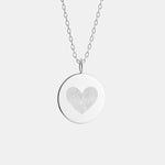The Danibydsgn Heart Fingerprint Coin Necklace in 925 Sterling Silver — a luxury pendant featuring two fingerprints delicately engraved into a heart shape, symbolising love, unity, and lasting connection in timeless fine jewelry.