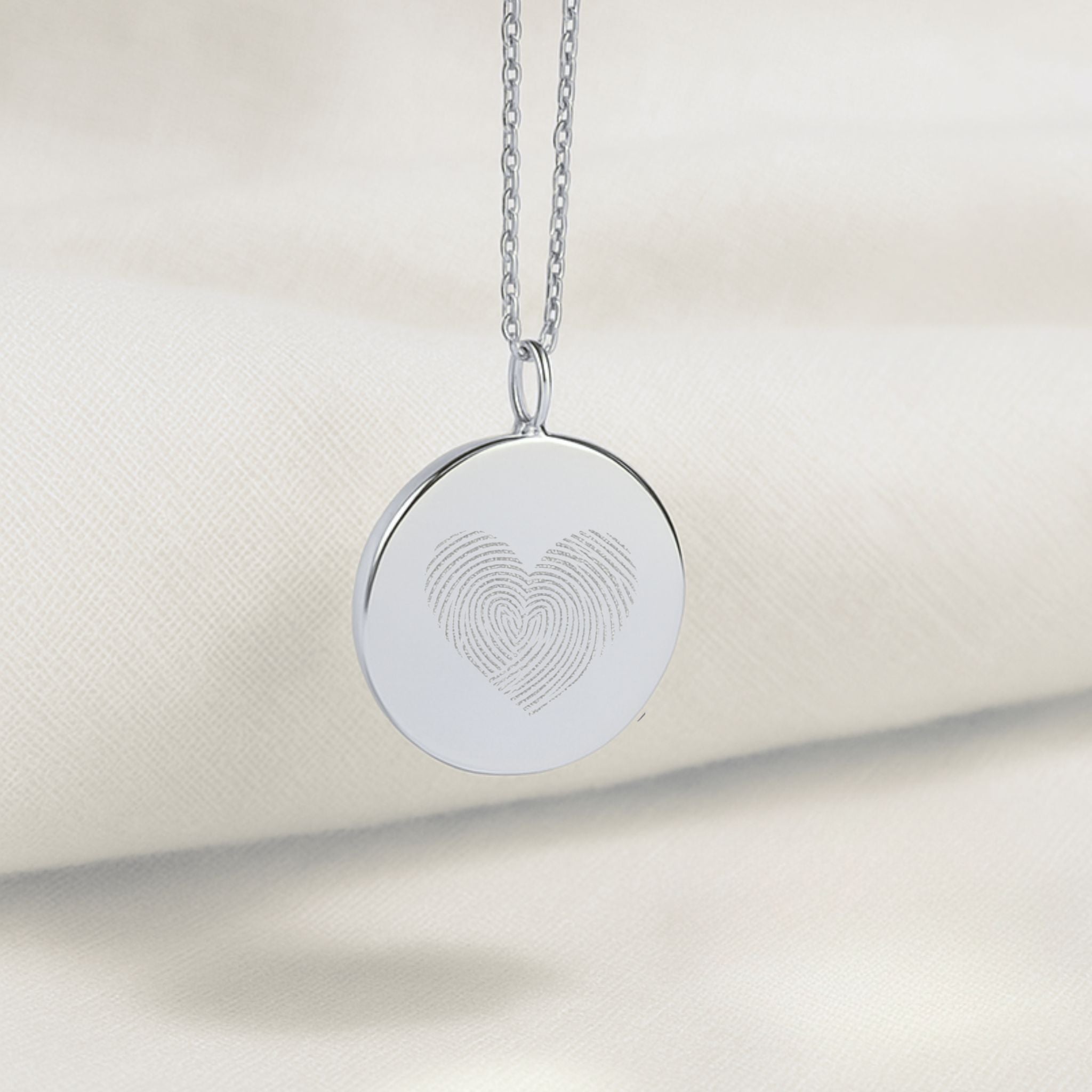 The Danibydsgn Heart Fingerprint Coin Pendant Necklace in 925 Sterling Silver, featuring two fingerprints delicately engraved into a heart shape — a timeless symbol of love and connection captured in luxury craftsmanship.