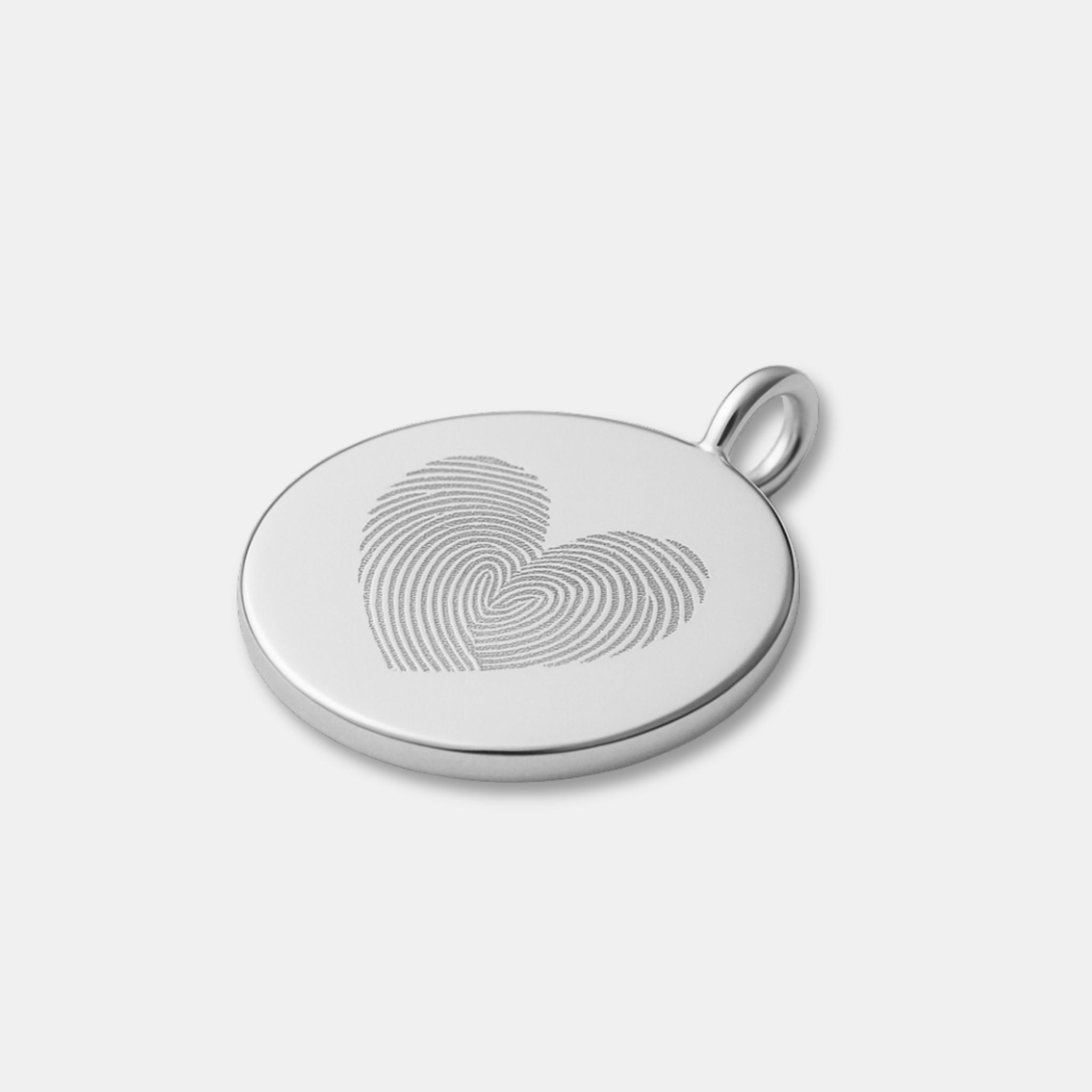 Close-up of the Danibydsgn Heart Fingerprint Coin Pendant in 925 Sterling Silver — showcasing two fingerprints engraved into a delicate heart shape, representing love and personal connection in timeless minimalist jewelry.